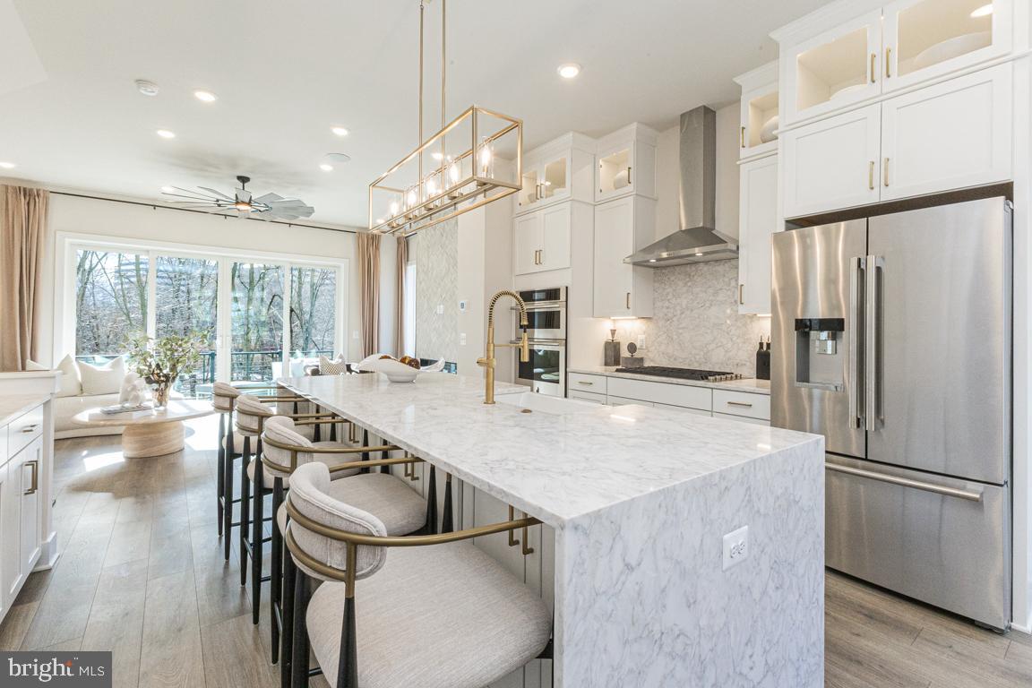 (Lot 42) Aug/Sept delivery.  Stunning new construction 4-level townhome in the hear of Reston!  Walk to Reston Town Center, metro stations and the new Reston Row Plaza.  This interior unit Whitman model features an open Recreation room with full bath on ground floor.  Oak staircase with open metal railings lead you to the breathtaking kitchen level with 10' ceilings and oversized casement windows, bringing tons of natural light into the home.  Designer kitchen with high end finishes including gourmet appliances, full size cabinet pantry and adjoining coffee bar.  Great room with fireplace overlooking double slider doors to the outdoor sky lanai - covered balcony.  Bedroom level has Primary suite with dual walk-in closets, spa-like seated shower and private watercloset.  Laundry room and 2 secondary bedrooms complete this floor.  The 4th level loft is a showstopper - open living with powder room, wet bar, and outdoor covered terrace leads to open air balcony with beautiful views overlooking the courtyard.  (PHOTOS OF MODEL HOME)