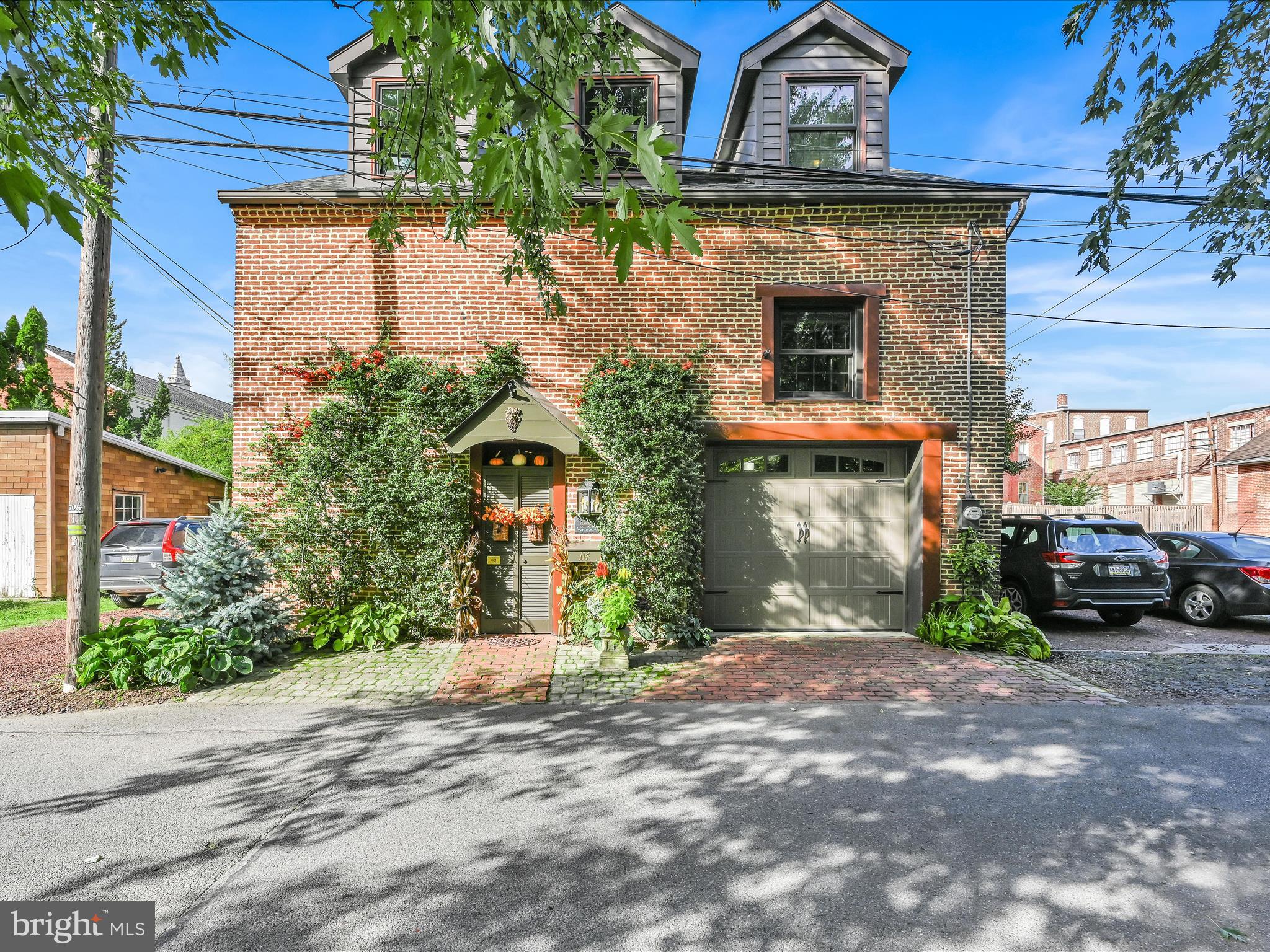 Beautifully Appointed Brick Carriage House that has the best of both worlds -Old World Charm with  some modern updates for convenience. Great Open Floor Plan provides lots of opportunities to adjust the space to your needs.  Large Great Room with wood-burning Fireplace and lots of built-in shelving, Family Room area on Main floor has a propane gas fueled stove.  Beautiful Kitchen with breakfast area, propane gas range top, Stainless Steel appliances, granite countertops, & numerous cabinets great for storage! Relaxing Sunroom off the Kitchen is spacious and bright and looks over the back stone patio surrounded by lush landscaping- perfect for entertaining and conducive to relaxation after a hectic day. Sunroom has beautiful wood floor, as does most of the house also. Sunroom is the only room heated by electric baseboard - the rest of the home has forced air heat. Loft could be used as a third bedroom.  Lg. glass-enclosed tile shower in master suite with 3 closets, Numerous wall shelving in the immaculate garage provides lots of storage as a bonus.  Great use of all the space - the floor plan can easily be adjusted to your family's lifestyle.  And located in a quaint town with plenty of opportunities for social entertainment along with the usual amenities.  It is meticulous and unique...don't miss this opportunity!  **Please note- park on the gravel area on the left side of the home,  park as close to alley as you can @ the beginning of the gravel area.  Can also park on the driveway leading to the garage if needed.