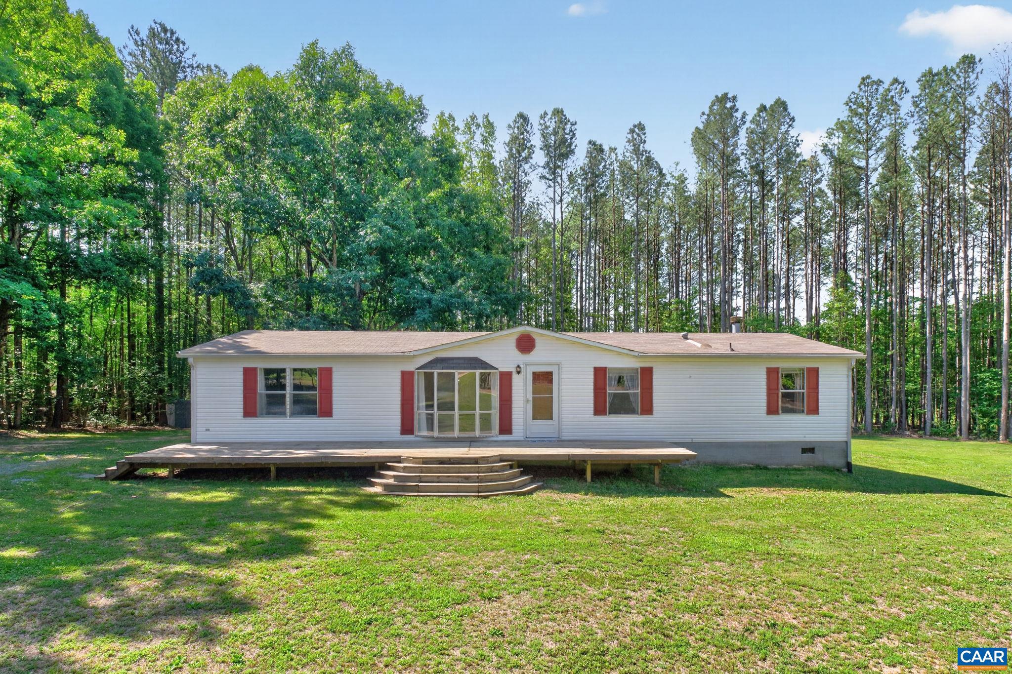Enjoy peaceful country living on nearly 5 private acres in Albemarle County! This well-maintained 3-bedroom, 2-bath home features an open floor plan, updated kitchen with butcher block island, stainless steel appliances, wood subway backsplash, and a stunning floor-to-ceiling stone gas fireplace in one of the living rooms. Updated master bathroom with double vanities and walk in shower. French doors lead outside to the spacious yard surrounded by mature trees, offering the perfect blend of privacy and convenience.  Roof was replaced in 2019.,Cutting Board,Formica Counter,Fireplace in Family Room