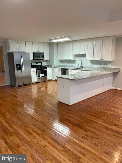 Enter into a large, bright and airy living area which opens up into a large kitchen and dining area.  Enjoy a gourmet kitchen with wood cabinetry, stainless steel appliances and granite countertops. On the main level you will also find a conveniently located half bathroom and a balcony off the main living area. Upstairs you will find two generously sized bedroom, a hall bath with ceramic tile and a huge master suite with ensuite bathroom that has a double vanity, ceramic tile shower and large soaker top.  On the lower level is an additional very large living area with another half bathroom.  Off of the lower living area is a brick patio which is perfect for relaxing.  This home features a 2-car garage with additional storage space.  This townhome is larger than many others in the neighborhood and features fresh paint and carpet throughout the entire home.  House is vacant and easy to show so schedule your showing today!