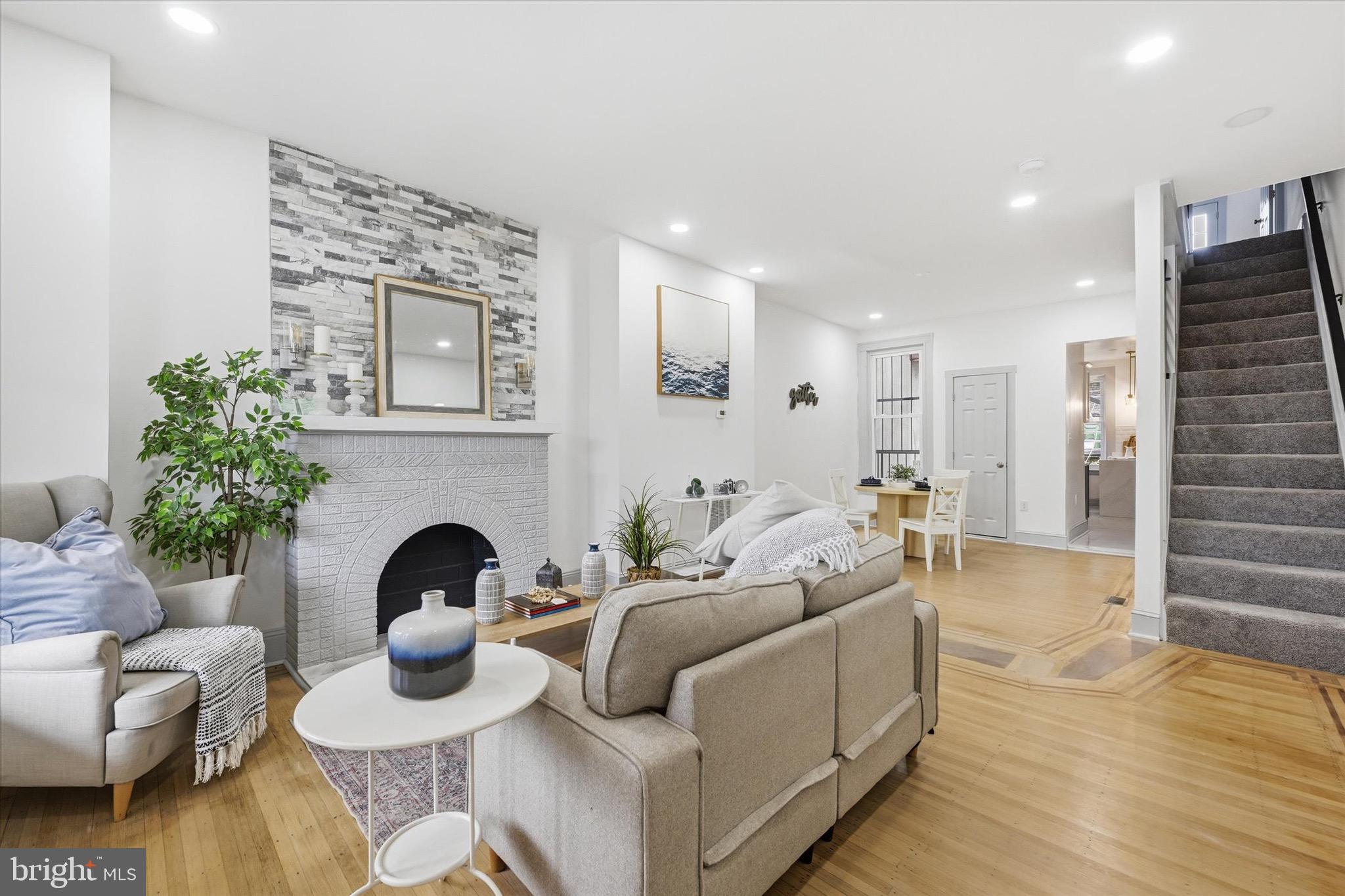 Completely renovated with the perfect blend of original Baltimore character and contemporary charm, this stunning home in the sought-after Abell/Charles Village area is ready to impress! Enjoy a welcoming covered front porch, rear porch, and private balcony along with a fully fenced rear yard—perfect for relaxing or entertaining. Inside, the open floor plan showcases original hardwood floors with beautiful inlay, exposed brick accents, bay/bow windows, and a decorative fireplace anchoring the spacious family room. The gourmet kitchen flows seamlessly into the main living space and is complemented by a convenient main-level powder room. Upstairs offers generously sized bedrooms and a stylish full bath, while the finished basement adds additional living space complete with a full bath—ideal for guests, a home office, or recreation area. Located just minutes from the world-renowned Johns Hopkins University Homewood Campus, the Baltimore Museum of Art, Charles Village, Remington, R. House, Penn Station, I-83, the Maryland Zoo, and Druid Hill Park, this location offers unbeatable access to some of Baltimore’s best dining, culture, entertainment, and commuter routes. Situated within the historic Abell neighborhood, known for its classic porch-front and bay-window rowhomes, this home delivers timeless city living with modern updates.