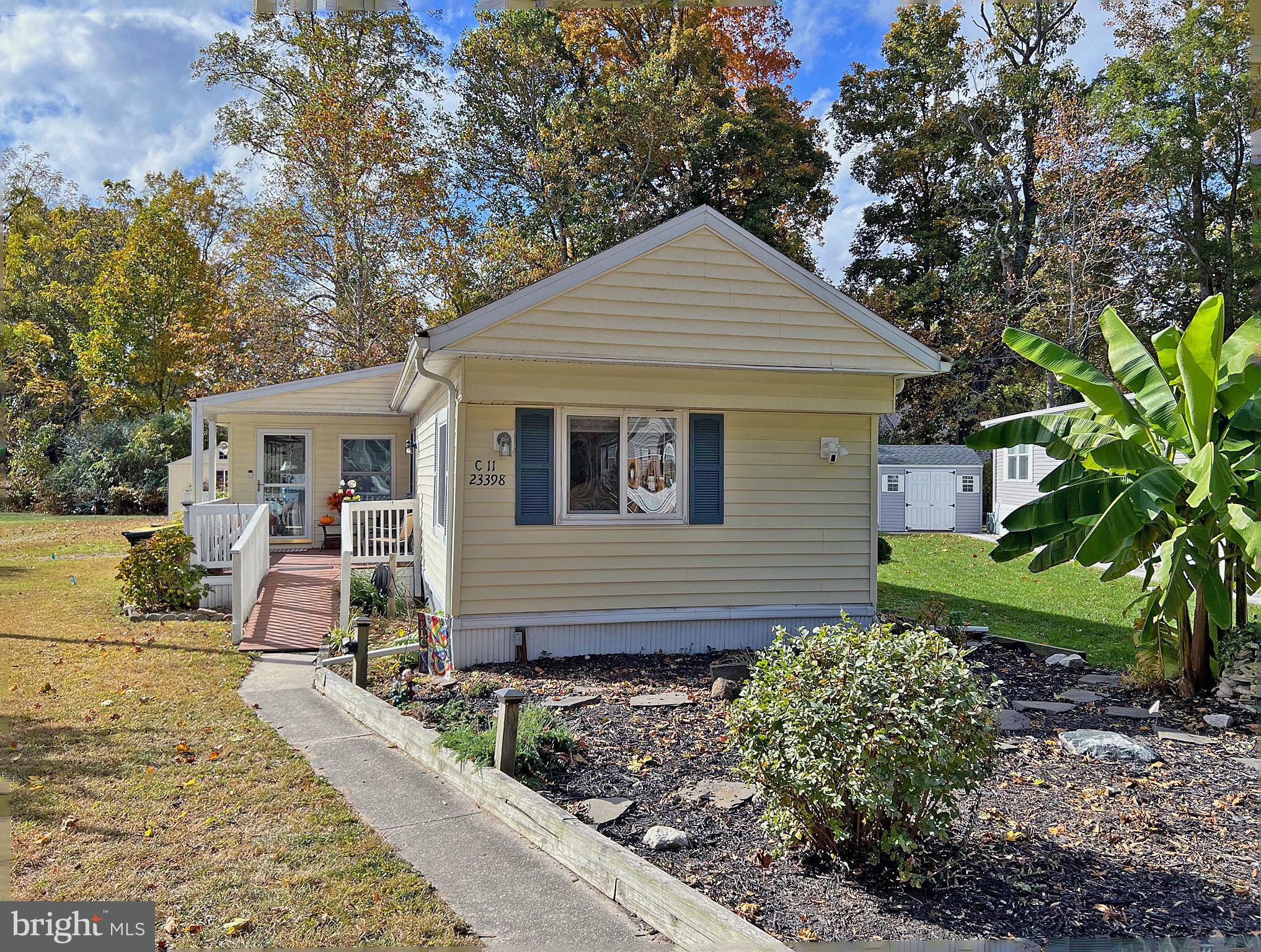 This home is approx. 1,500 sq. ft. with its three additions: a 10'x36' sunroom, an expanded laundry room, and an addition at the rear bedroom.  Additionally, there's a 3-season space at the back of the sunroom for extra storage. The home also boasts three fireplaces - a gas fireplace in the sunroom, an electric fireplace in the living room, and an electric fireplace in the main bedroom. Newer replacement windows. Newer Lennox HVAC for the main house. Updated kitchen cabinets and granite countertops. Remodeled front bath. Newer flooring. Split bedroom plan. The front bedroom has a walk-in closet and is en Suite with tub/shower bath. The back bedroom is next to the second full bath in the hall, which has a big, step-in stall shower. You are going to love the fenced backyard, which has a covered patio area and a large boardwalk-style deck. You'll also find an oversized 240 sq. ft. shed with electric and storage shelving. Small attic space above the back bedroom. This home is about an equal distance to both of the pools and the playgrounds. The marina is just down the street. Boat slips for rent (may be a waiting list) and a large parking lot for your boat trailer if you want to use the community boat ramp. Leasehold interest renews annual: Current lot rent is $718/mt. with renewal on Jan. 1, 2026. Lot rent includes water, sanitary sewer, and trash/recycle. Homeowner pays for electric and metered fuel. Verizon FiOS available or standard cable/Internet service. Two (2) pets are allowed in Angola Beach. Golf carts are permitted. Community owner, Hometown America, requires a park application from the Buyer. Acceptance will be based on 1.)income verification; 2.)credit bureau score, including debt-to-income-ratio; and 3.)clean criminal background check. All adults, 18-years-of-age or older, who will occupy the home must apply.  Installment/Chattel Loan may be available to qualified borrowers from only a very few Lenders that specialize in loans for manufactured homes on leased land. Closing costs will include a 3.75% DMV Fee (transfer tax) and a fee to a settlement agent, who will coordinate the closing and the transfer of documents.
