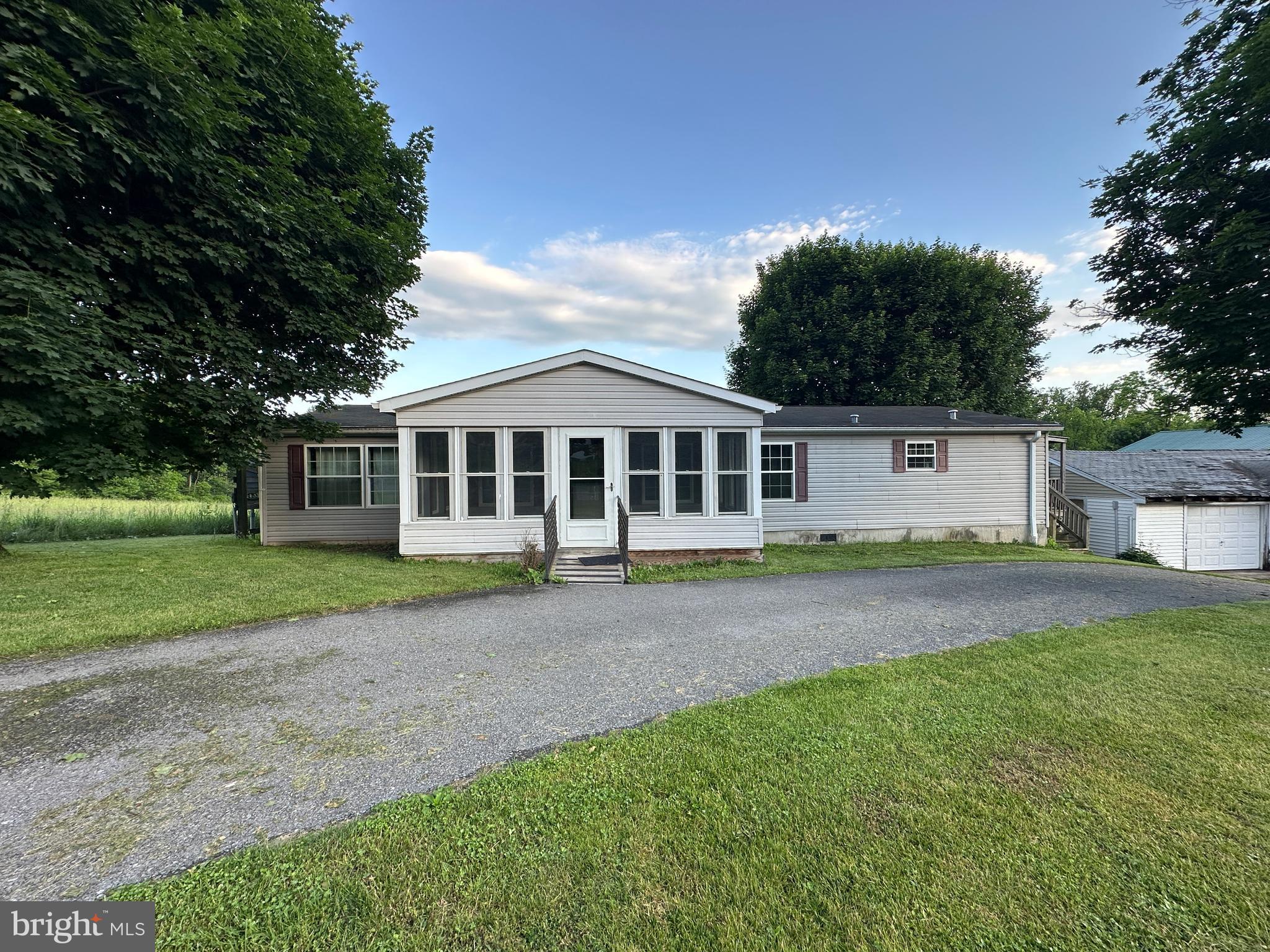 EXCELLENT RANCH-STYLE HOME IN MCCONNELLSBURG, PA! Nestled in a beautiful setting with outstanding views, this well-maintained property offers both comfort and convenience. The home features 3 bedrooms, including a spacious primary suite with a private en-suite bath and large walk-in closet. Additional highlights include a welcoming living room with fireplace, kitchen, laundry room, sunroom, and more. Built in 2007, this mobile home sits on a permanent foundation and offers a functional layout. The property also includes a 3-car detached garage, providing ample space for vehicles, storage, or a workshop. Conveniently located just 3 miles from Rt. 16 and within easy reach of Rt. 30 and Rt. 522, this home offers peaceful country living while remaining close to major routes and amenities. Come see the potential and make this home your own!