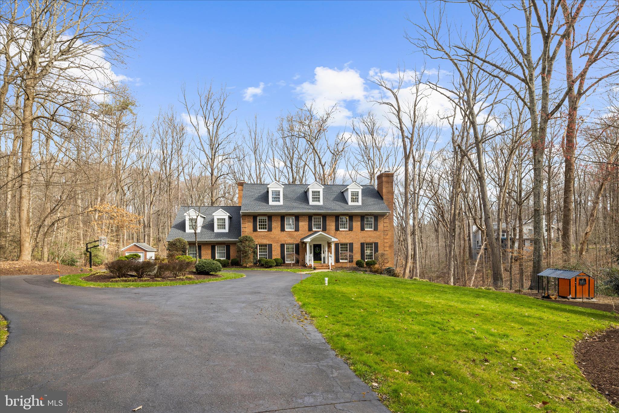 Tranquility and nature awaits you in this timeless all-brick estate, thoughtfully designed for both everyday living and MULTI-GENERATIONAL l flexibility — offering the rare feeling of living in your own private retreat while still being just minutes from the heart of Annapolis. With over 5,500 square feet, multiple private living areas, and the potential for dual primary-style suites, this home is perfectly suited for extended family living, an au pair setup, long-term guests, or evolving household needs.

A long private drive opens to a circular driveway welcoming you home to a picturesque landscape filled with mature trees and open space. Complete with a three-car garage and separate shed, there’s plenty of room for vehicles, hobbies, storage, and weekend projects.

Your home unfolds with beautifully designed living space, where hardwood floors, freshly painted interiors, abundant natural light, and generous room sizes create a warm and inviting atmosphere. The main level offers two spacious living areas, both with cozy fireplaces, a formal dining room, and a private office that could easily function as a main-level bedroom — creating additional flexibility for guests or multi-generational living needs.

The second level features four spacious bedrooms and three full baths, along with a large bonus room over the garage offering endless possibilities for a playroom, studio, secondary living area, or potential second primary suite. The expansive primary retreat is complete with its own fireplace and large private bath featuring a soaking tub, separate shower, and dual vanity.

The third upper level provides two additional bedrooms and a full bath, creating a private retreat ideal for guests, an au pair suite, or extended family.

The finished lower level adds even more versatility with a large recreation room, exercise space, abundant storage, and walkout access to a second patio leading to the generous backyard.
The lower backyard offers a secluded setting perfect for bonfires, s’mores, and evenings gathered with friends and family under the trees.
Your outdoor experience continues with an expansive deck overlooking 2.25 private acres of surrounding woodland — an ideal setting for summer dinners, quiet mornings with coffee, or simply decompressing while listening to nature. Fresh eggs await from your very own chicken coop — and the chickens can convey if buyers wish.

Perfectly positioned for your private oasis, yet just minutes from Annapolis, the Naval Academy, commuter routes, and local shopping.  WATER ACCESS AND MARINAS JUST MINUTES AWAY- 3 MILES!

A rare opportunity to enjoy space, privacy, flexibility, and nature while staying connected to everything the Annapolis area has to offer.
