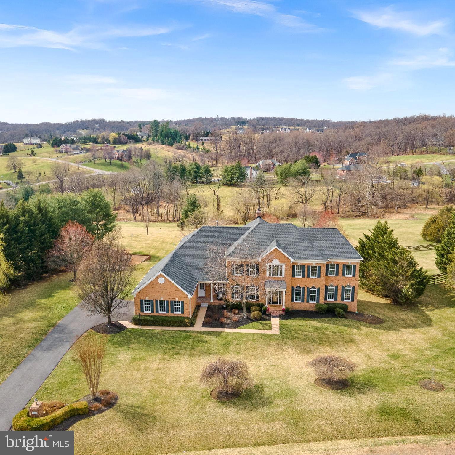 Luxury and comfort define this renovated estate home nestled within the prestigious and private community of Shenstone Farm with breathtaking views of the rolling countryside on 3.22 acres.  This 5 BR / 8 BA home offers 8,200 Sq Ft of luxury living space.  Extensively updated with $300,000 in modern upgrades and luxury finishes.  Step into the two-story foyer, where a stunning staircase sets the tone for the elegance that awaits. Refinished hardwood floors on the main level and newer carpeting upstairs provide a fresh, sophisticated backdrop for any style.   The main level includes a large great room, bathed in natural light with an expansive wall of windows and a raised stone hearth fireplace showcasing breathtaking year-round views.   Just off the great room, a private corner office with a bay window and built-in bookshelves offers the perfect work-from-home retreat.  The light filled sunroom  is an ideal space for music, reading, or quiet relaxation.   At the heart of the home is the NEW Gourmet Kitchen, a true chef's dream masterfully designed with:  rich, elegant solid wood cabinetry, quartz countertops & custom tile backsplash, all-new appliances, including double wall ovens, 36" WOLF GAS RANGE, Professional MONOGRAM 48" BUILT-IN refrigerator.  The large island offers even more cabinet space (on both sides) and a place to gather.   The new Butler's Pantry enhances both everyday living and effortless entertaining.  Convenient access to the mudroom, laundry room, and side-porch entry.   Step out on the new deck to enjoy your morning coffee.   The upper level offers 5 spacious BRs each with their own private, updated BAs.  The primary suite is a serene sanctuary, featuring new hardwood floors, a relaxing sitting room with fireplace, a newly renovated luxury bath with walk-in custom tile shower,  soaking tub for ultimate relaxation and new designer vanities.   Closets include custom built in closet system for organized storage.  Expansive Walkout Lower Level includes a family room with raised brick hearth fireplace, new custom bar with counter seating, wine closet and wine fridge, room for game tables, a new home theater room with plush new carpeting, a full bath and a guest room/mother-in-law suite.   French doors lead to the beautifully landscaped backyard, complete with a natural stone patio, built-in stainless gas grill, and charming carriage lights.  Every surface of this home has been updated and refreshed.  Additional updates include Fresh Interior Paint, new landscaping & power-washed windows, Roof (2022), New 75 gallon Water Heater (2025), new Firepit and gravel area, gutters cleaned (2025).  Located just minutes from downtown Historic Leesburg, Ida Lee Rec Center, and Loudoun County Fairgrounds, this estate is near wineries, fine dining, shopping, and the outlets—offering the perfect blend of countryside elegance and modern convenience.