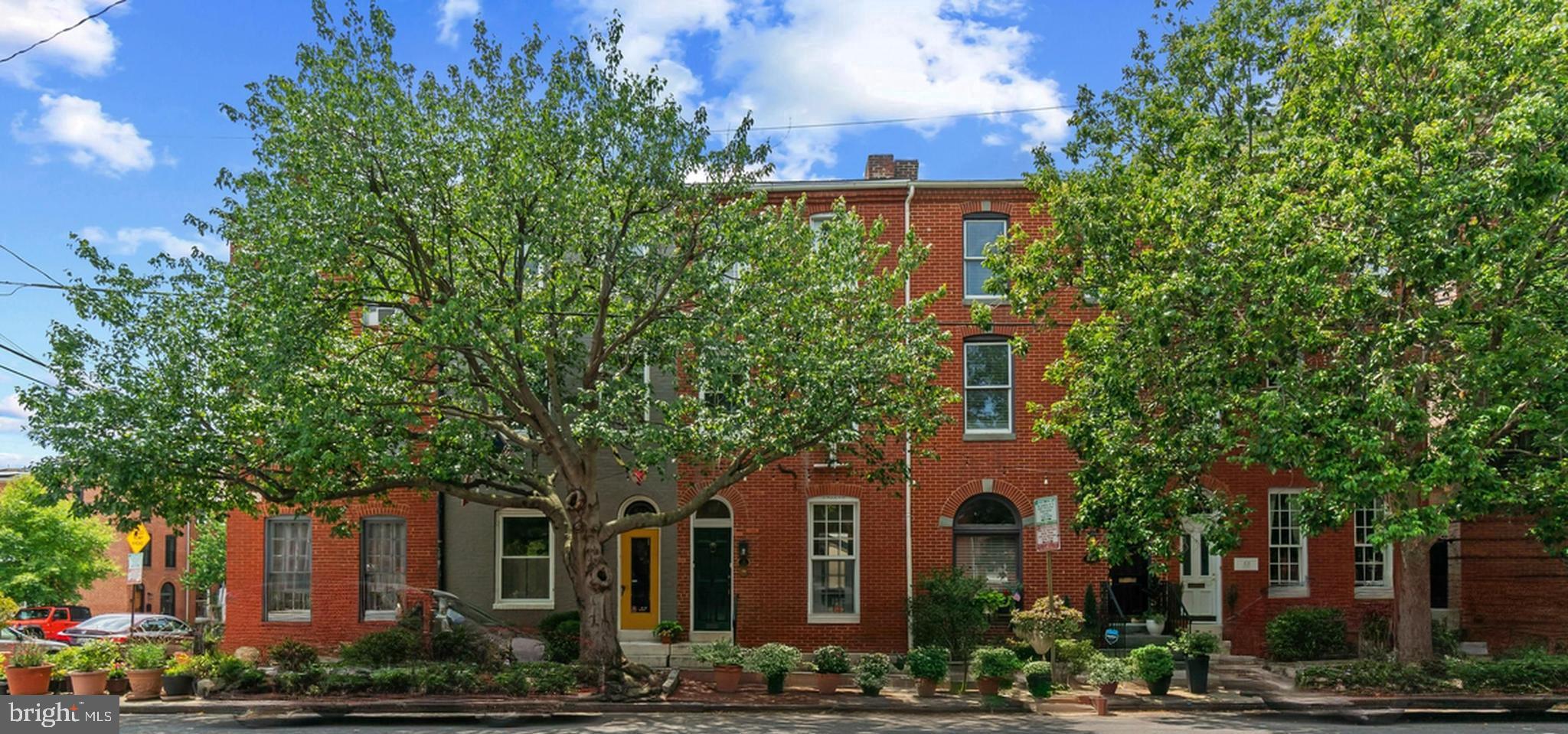 Architecturally distinctive three-level row home located on one of Historic Federal Hill’s premier tree-lined blocks. Located moments from Baltimore’s most sought-after attractions. This beautifully maintained 4-bedroom, 2.5-bath residence seamlessly blends timeless historic character with thoughtful modern updates. The sun-filled main level features soaring 12-foot ceilings, original hardwood floors, custom built-ins, and expansive living and dining spaces . A conveniently located powder room leads to the gourmet chef’s kitchen, complete with a custom built refrigerator, gas range, abundant cabinetry, built-in media center, and breakfast area. The kitchen opens directly to a private courtyard, creating the perfect indoor-outdoor living experience. The upper levels offer four spacious bedrooms, including a luxurious primary bedroom with a sitting area, generous closet space, and an updated bath featuring modern finishes. The fourth bedroom is currently configured as a home office with extensive built-ins and dedicated workspace, ideal for today’s remote professional. Additional highlights include updated bathrooms throughout, dual-zoned HVAC, a partially finished basement providing flexible living space, and a separate storage room. Ideally situated just two blocks from the Inner Harbor and within walking distance of Federal Hill Park, Cross Street Market, downtown Baltimore, and both Ravens and Orioles stadiums, this exceptional home offers the perfect combination of historic charm, modern comfort, and an unbeatable location in one of Baltimore’s most iconic neighborhoods.
Be sure to also watch the video!