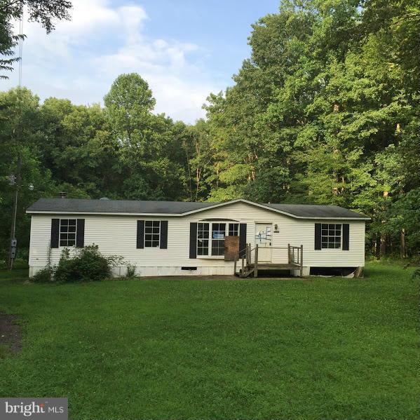 Manufactured home in need of cosmetic repairs. Large lot. Auction style listing. Sold strictly as is, where is.