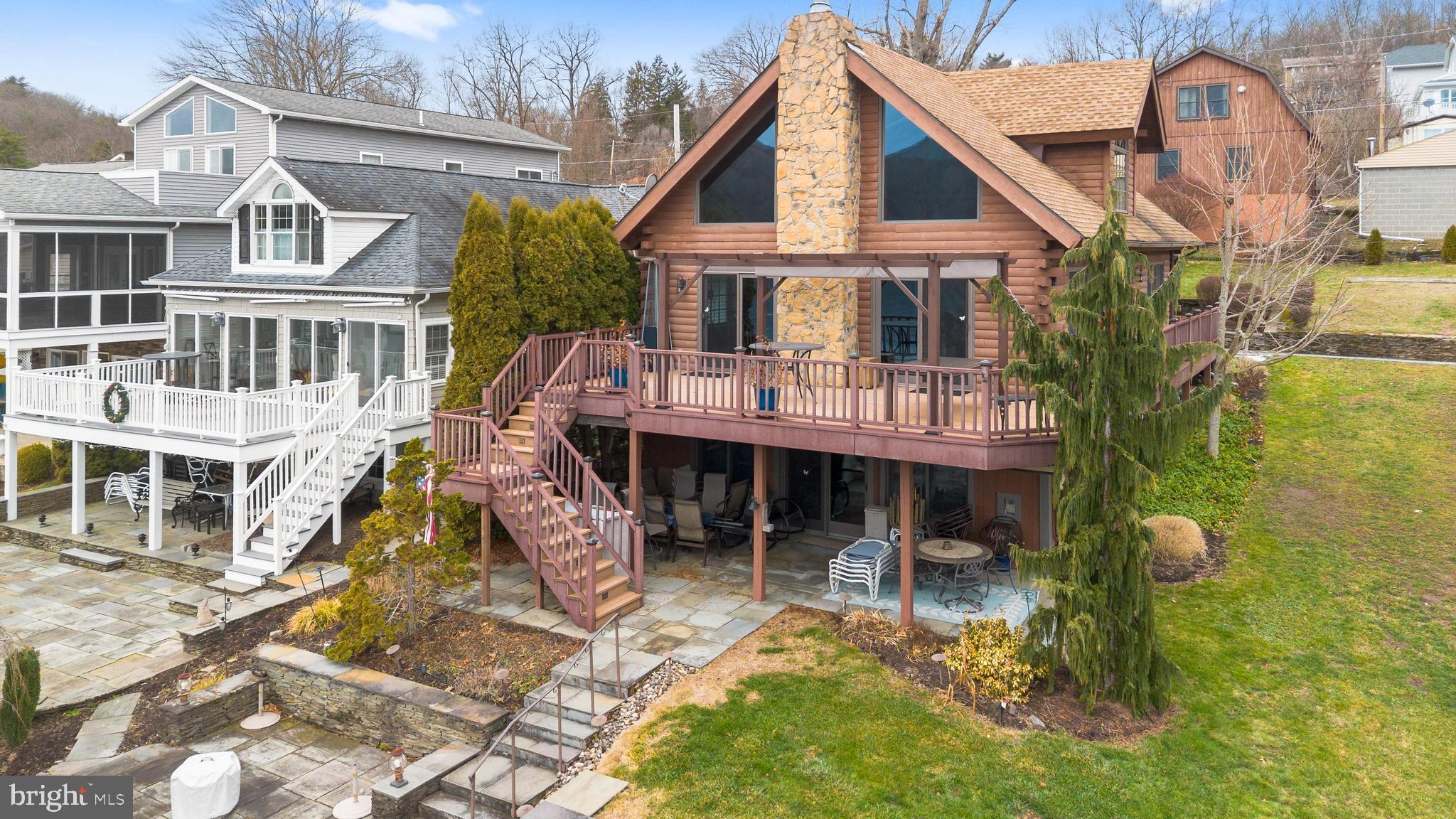 The Lakefront Home & Lake Community you have been waiting for and it's conveniently located a short drive from Clarks Summit. 1st home, vacation home, retirement home, this stunning & impeccably cared for log home has it all. All the boxes are checked: lakefront on Lake Winola, your very own dock & boat lift, gazebo on the dock and storage shed. Step inside to soaring ceilings in the living room & dining area with views of the lake. Sliding glass doors lead out to the wrap around deck to further enjoy sitting under the covered pergola and watching the boaters & bald eagles. In the living room is a new fireplace for those cold winter nights. Above are custom windows at the peak & Anderson Series 400 windows throughout. . As you walk back towards the kitchen there is a bedroom with a split heat/ac system. Across the hall is a bathroom & the laundry area. The kitchen has been recently remodeled and upgraded with lighted cabinets and storage galore including a pantry that lights up when you open the doors. Gorgeous Quartz counters. Propane stove and double convection oven, SS Fridge & dishwasher. Oversized island with storage & seating. Upstairs is a loft area outside of the Primary Bedroom. Auto Velux Skylight in the bathroom and his and her sinks. Ring Door Bell here as well. Walk in Closet with a secret door to attic storage. The lower level has 3 more bedrooms with Split heat/ac systems and another bathroom. Also A/C. The Great room leads out to the rain protected patio thru sliding glass doors. It is covered by the deck above. Once outside you can walk to the firepit patio and down to the dock. Oversized garage with workshop and finished upper level. Enjoy boating, fishing golf and terrific dinners at the Canoe Club. August is the Water Carnival. Less than an Hour to Binghamton NY. NYC, Phila, Harrisburg are just over 2 hours drive. Camelback, Elk Mountain, Montage Mountain, Outlets, Casinos, Fairs, Street Carnivals all less than an hour away.
