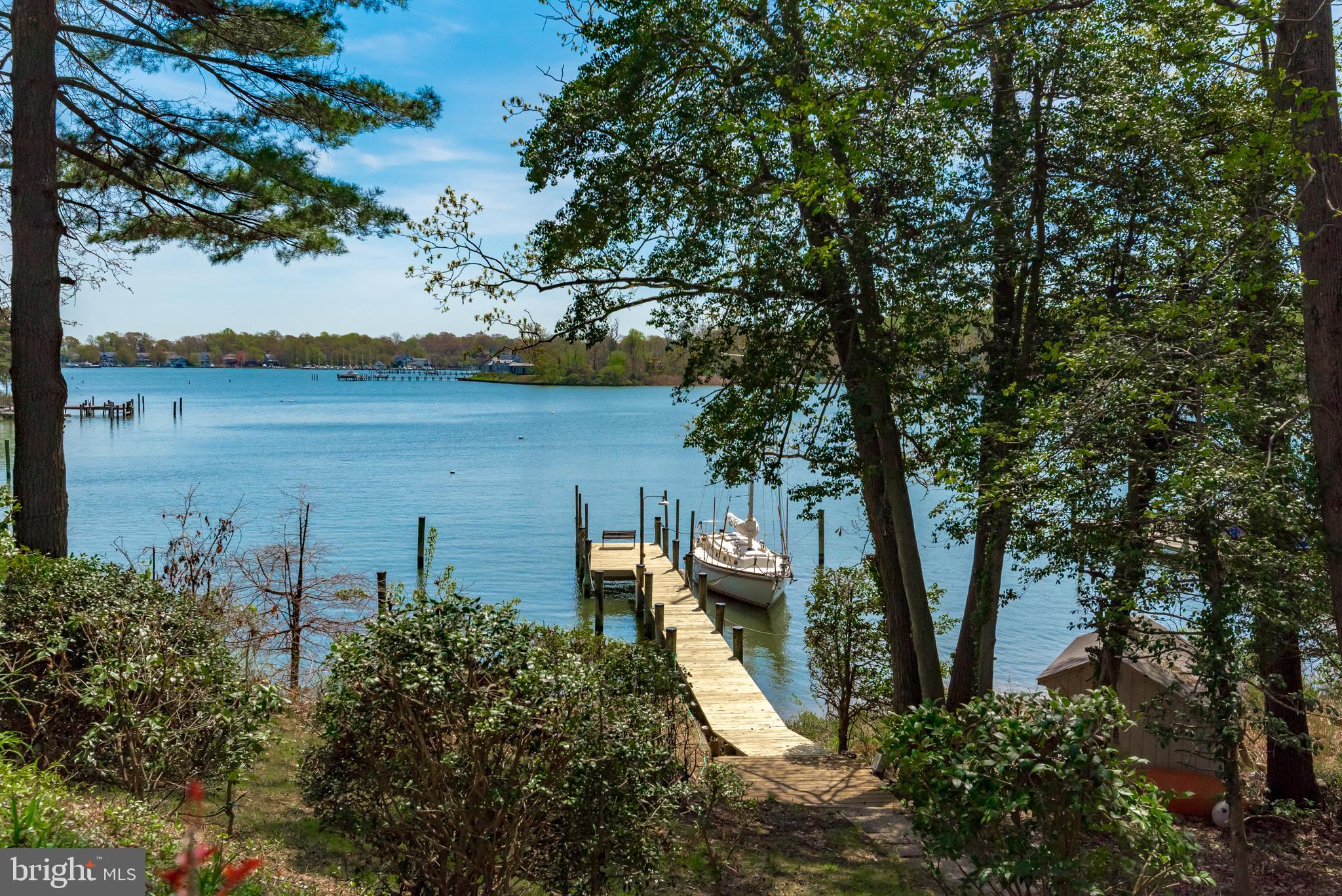 This property boasts over 200 ft of water frontage on protected Lake Ogelton with stunning views. This absolutely charming 2 bedroom, 3 bath contemporary with open floor plan is a boater's delight, situated well out of the flood plain with a gentle slope to the water,  4ft+MLW at  your private pier and storage shed for all your boating needs. Move to the desireble community of Annapolis Roads with amenities galore. Enjoy the beach, playground, field, grill & picnic area, boat ramp, kayak rack, and wooded walking  trails. You can access all that the community has to offer or retreat to your private oasis with bird and boat watching from your ever changing rear deck view. Home in need of a full renovation.