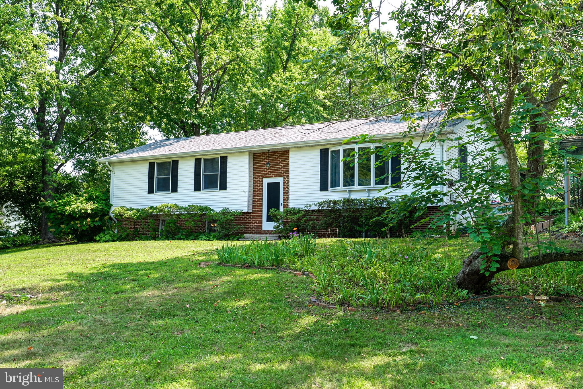 A rare opportunity to own a classic two-story split-level home in Chestertown — set on a large, shaded corner lot just a few miles to Downtown Chestertown, Washington College, the weekly farmers market, the town's annual festivals, and only steps to locally loved restaurants and everyday conveniences. This is the kind of home that simply isn't built anymore: classic lines, original details, and the quiet character that comes from decades of careful ownership. Step inside and the home tells its story with original trim, classic proportions and timeless architectural touches. The two-story split-level floor plan offers a thoughtful separation of living and sleeping spaces, with a sun-filled sunroom that works beautifully as a screened porch when the doors are all open or as extra living space during the shoulder seasons. Two of the bedrooms sit on the upper level, while two large bedrooms flow comfortably below. Out back, the large, gently sloped corner lot offers privacy, mature trees, and room to garden, entertain, or simply enjoy a quiet afternoon. The setting feels tucked away, while the rest of Chestertown is just a short jaunt from the front door. The two-bay carport keeps your vehicles safe from the elements in the wide stone driveway. What truly sets this home apart is its condition. It has been maintained impeccably — spotlessly clean, carefully tended, and gently lived in. The HVAC system is new, and the kitchen and laundry appliances are all young as well, giving the next owner the best of both worlds: classic character on the outside, modern mechanicals where it counts. The remaining finishes offer a thoughtful canvas for the next owner to put their own stamp on it, with the confidence that the bones and the care have already been handled. Classic character, pristine condition, and convenience to it all.