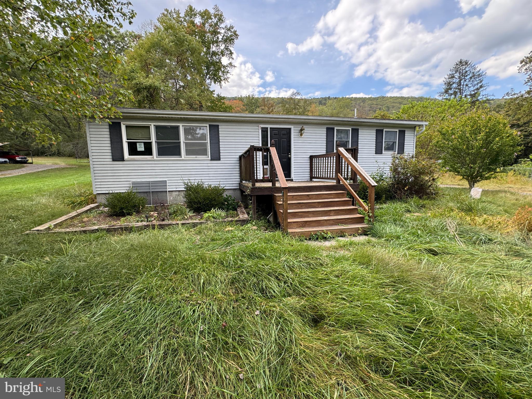 Spacious ranch-style home offering over 2,000 square feet of one-level living on nearly a half-acre in Hampshire County. The layout includes a large family room, country kitchen with adjoining breakfast area, and several flexible rooms that may serve as bedrooms, office, or hobby space. Hardwood floors, vaulted ceilings, and skylights add light and character throughout.

A detached two-car garage with an upper-level workshop and balcony, plus additional kennel space, provides plenty of utility. Convenient location with easy access to Winchester and surrounding areas. Home is being sold as-is and presents a great opportunity for the right buyer.