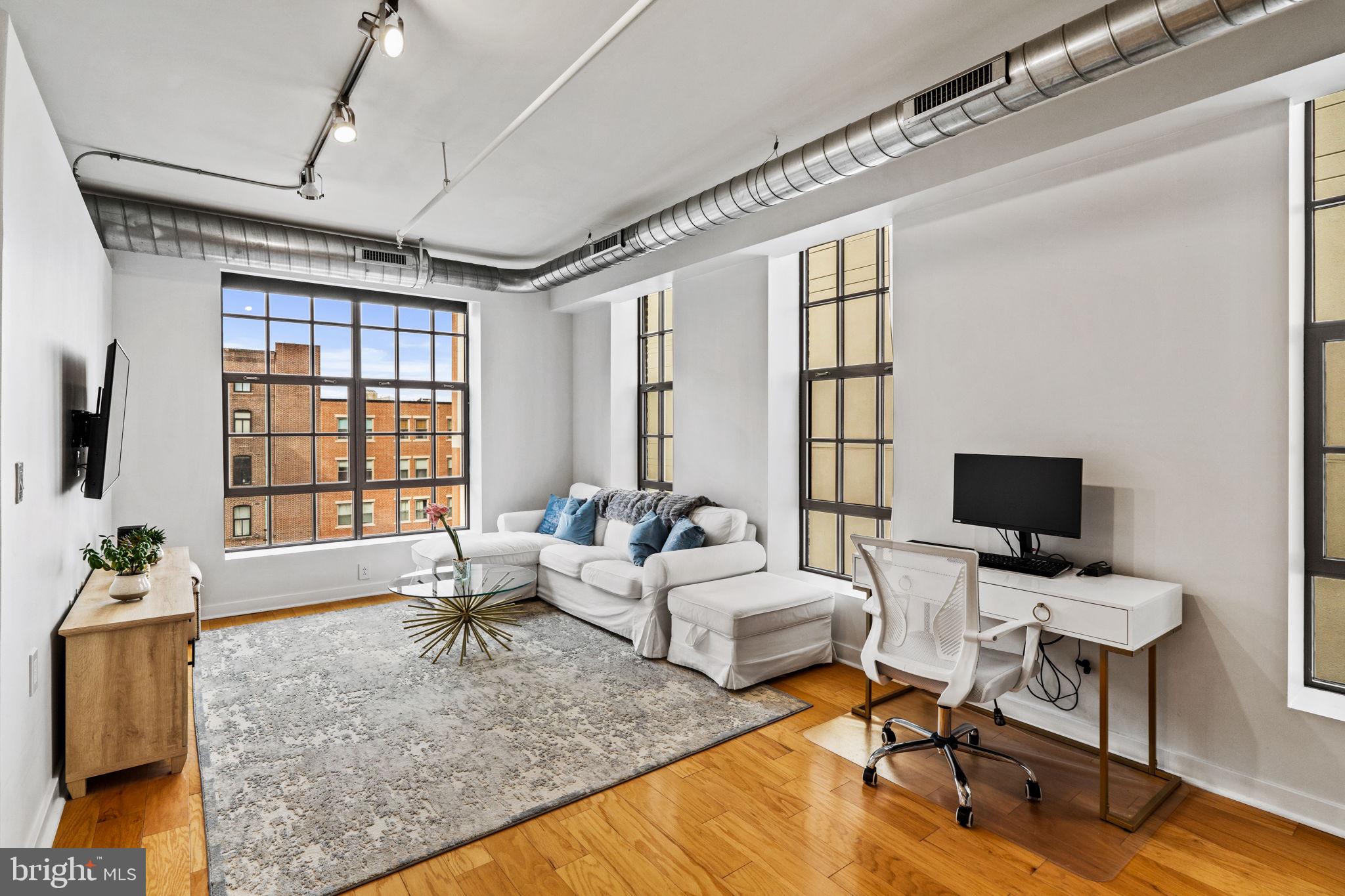 Welcome to The National Condominiums, a private gated community in the heart of Old City, where historic charm meets modern luxury in this stunning two-bedroom, two-bathroom condo. This exclusive development offers exceptional amenities, including an on-site underground parking garage with one year pre-paid parking for your vehicle, bike storage, and a private, gated courtyard. Step inside to this southwest facing CORNER unit located on the TOP FLOOR and you will discover soaring 11-foot ceilings, exposed poured concrete walls, exposed ductwork, and oversized industrial  windows that flood the rooms with natural light to create an industrial-chic aesthetic feel. This thoughtfully designed unit combines functionality with modern elegance, offering ample storage and stylish living spaces. A coat closet near the entrance keeps everyday essentials organized and the guest bedroom features a walk-in closet. The open-concept kitchen is a standout, featuring a barstool-height countertop perfect for casual dining or entertaining, complemented by newer appliances that elevate both form and function. Enter into the spacious and sunlit primary bedroom, where a hallway lined with ample closets leads to the en-suite bathroom, offering abundant storage space for all your wardrobe needs.The National is just steps from Elfreth's Alley the nations oldest street, Philadelphia’s finest restaurants, Riverwards Produce,  coffee shops, boutiques, art galleries, and historic landmarks. Immerse yourself in the neighborhood’s vibrant culture, from annual events like Old City Fest to First Friday evenings, where galleries and studios open their doors to art lovers. This dynamic community combines historic charm with modern energy, offering an unparalleled lifestyle in one of the city’s most coveted locations.