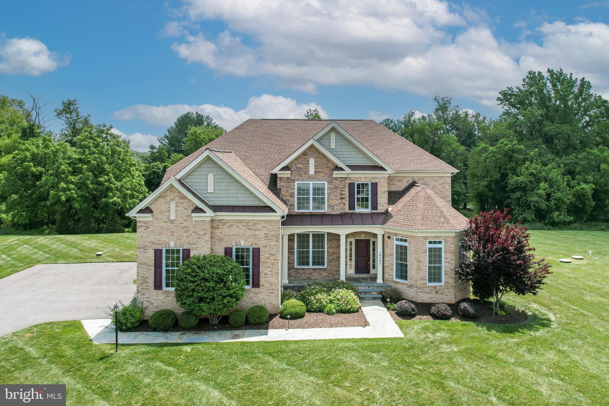 Rarely available in the coveted Weatherstone community, this exceptional 6,200+ sq. ft. estate is situated on over two acres at the end of a quiet cul-de-sac. A charming covered front porch welcomes you into a light-filled open floor plan featuring rich hardwood floors, custom built-ins, a private office, and a dramatic two-story Great Room with a stone fireplace and wall of windows. The gourmet kitchen is designed for both everyday living and entertaining, offering an oversized granite island, premium stainless steel appliances, and abundant workspace. A main-level bedroom with a private entrance and full bath provides ideal flexibility for guests, multigenerational living, or an au pair suite.  Upstairs, the luxurious primary suite features a private sitting room, spa-inspired bath, and oversized custom walk-in closet. Three additional bedrooms and two full baths complete the upper level. The finished lower level expands the living space with a spacious recreation room, large hobby room with extensive built-ins, fitness room, full bath, and abundant storage. Outdoor living is equally impressive, featuring a low-maintenance Trex deck, expansive stone patio with outdoor kitchen, and built-in fire pit, all overlooking a serene wooded backdrop. Ideally located near top-rated schools, premier hospitals, upscale shopping, dining, and major commuter routes including I-695 and I-83.