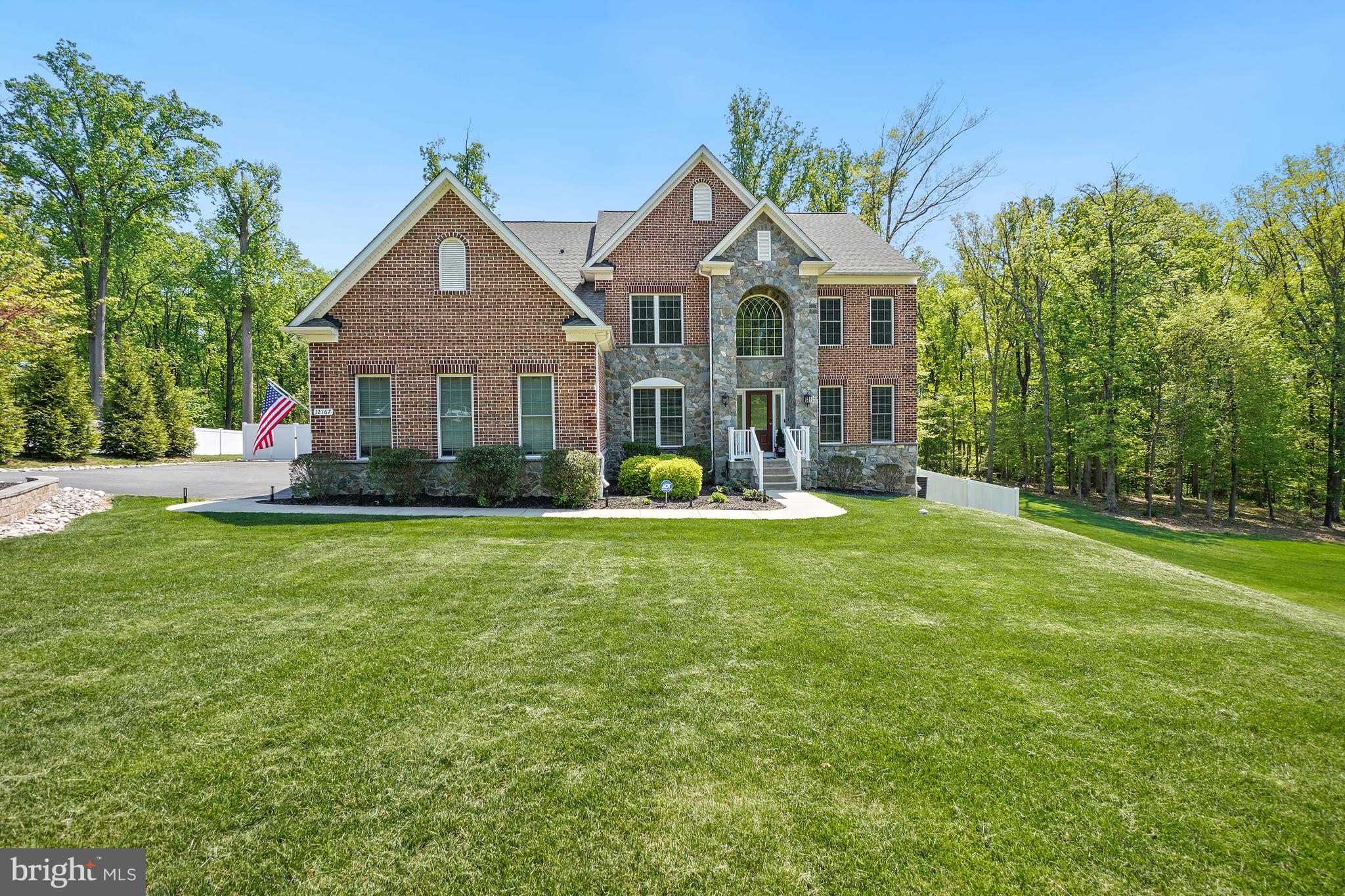 Welcome to 12167 Fulton Estates, a country club–style home set on a beautiful tree-lined lot. A three-car side-loading garage and inviting curb appeal create a striking first impression. Inside, a two-story foyer opens to formal living and dining rooms, ideal for both everyday living and entertaining.  The rear of the home features a chef’s kitchen with a large island, stainless steel appliances and granite countertops which flow seamlessly into a bright sunroom and a dramatic two-story family room. A main-level bedroom suite adds flexibility for guests or multi-generational living. Upstairs, the spacious primary suite offers two walk-in closets and a spa-inspired bath. Three additional bedrooms and two full baths complete the upper level. The finished lower level is designed for recreation and relaxation, featuring a large rec room with space for a game table, a home gym, full bath, and a flex room with walkout access to the backyard.
The backyard is a fantastic gathering space for family and friends...complete with a swimming pool, outdoor bar with beer taps, a firepit and a storage shed.  This home provides easy access to major commuter routes, the shoppes and restaurants of Maple Lawn as well as top rated Schools,  Don't miss this incredible opportunity to make this spectacular house your next home.
