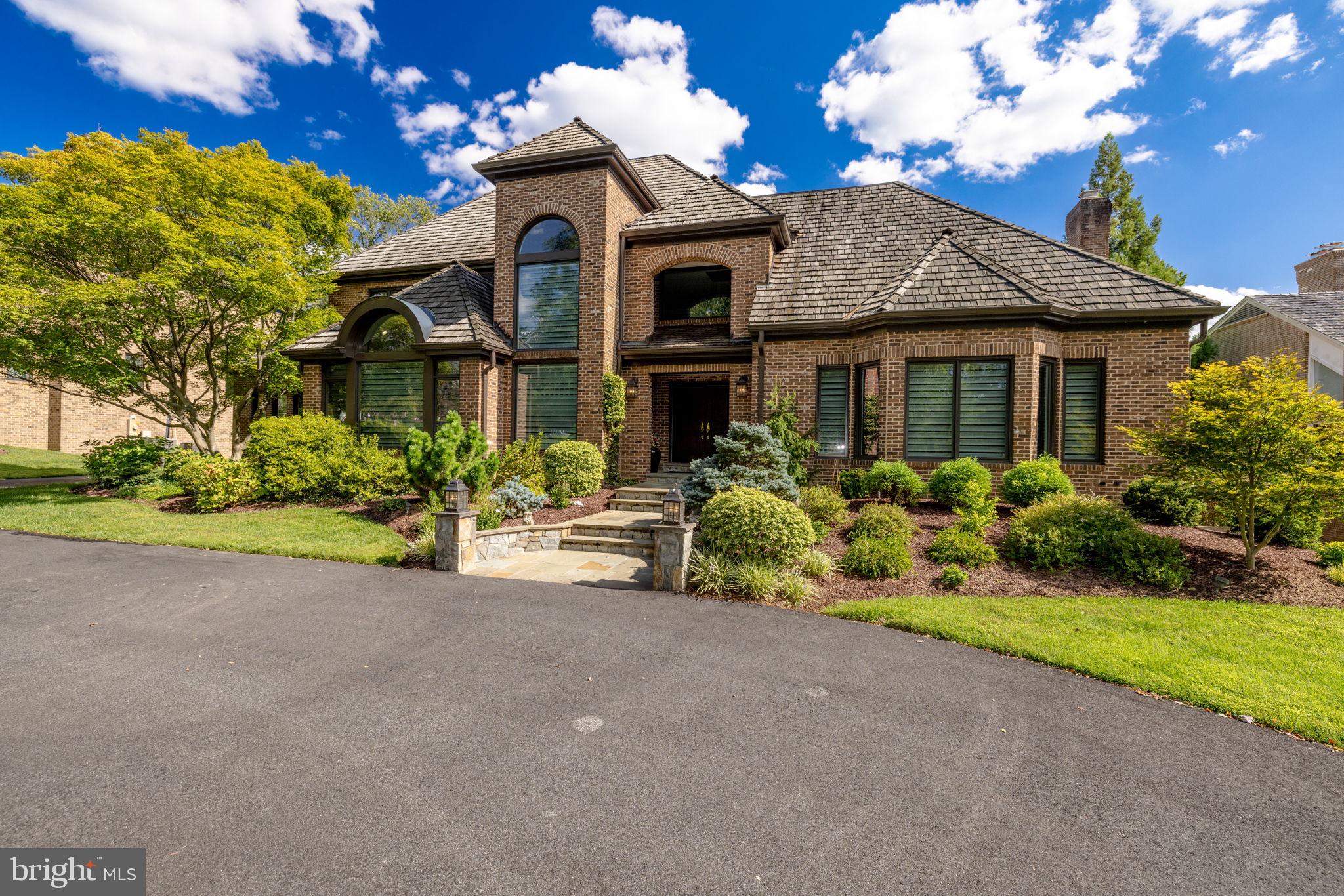 Welcome home to an absolute joy of a custom home in one of the most enviable locations in Potomac.  From its handsome, all brick exterior, with its timeless transitional architecture and magnificent grounds, to the lovingly cared for and thoughtfully designed drama of its interior, this extraordinary home, is  a rare offering.  Main Level:   2-story reception area  accentuated  by a  5-tier, modern glass chandelier, art lighting, and walk-in coat closet; refinished hardwood floors throughout; Great Room with  15’ vaulted ceiling, double-skylights, a floor to ceiling  gas fireplace flanked by built-ins with underlit shelving, wine refrigerator and 2 refrigerated beverage drawers, double French doors with Palladian window accent opening to lush grounds, deck and screen porch. Open, center island eat-in Kitchen with new granite countertops and backsplash,  Wolf range,  plus double oven, 2 wine and 1  beverage fridge, 2 pantries, and informal Dining area with 5 large windows and 3 skylights floating in a 12’ vaulted ceiling with custom window treatments. Living Room with  a wall of 6’ tall windows with custom window treatments.  Large Entertaining sized Dining Room.  Wood-paneled Office with built-ins, custom window treatments and a wall of oversized windows with Palladian window.  Main level Primary Suite with gas fireplace, sitting area, dual walk-in closets, dual vanities with back lit mirrors, renovated bath and shower 2024, heated floors, new soaking tub and separate steam shower with 2 shower heads, intelligent toilet, 2 linen closets, plantation shutters and private access to screened porch and deck.  Powder Room  (2023) with nail head wallpaper, floating quartz vanity,  and custom sconces and fixtures.  Full Bath #2 with separate water closet; Large Laundry/Mud Room with side yard access.  3-car, rear load garage.  Upper-Level:
New carpet at  staircase and hallway.   Hardwood floors throughout.  Bedroom #2 w/ en-suite bathroom #3 (2024) w/ new tiling, vanity, backlit mirror, intelligent  toilet and walk-in shower.  Full J&J  Bath #4 (2024), separate water closet with tub and intelligent  toilet, new tiling, double sink vanity and granite top and back-lit mirror.  Bedrooms #3 & #4 with double closets.  Office #2 with French Doors.  Separate sitting/game table area overlooking the reception area.  Full Daylight Lower-Level:
New LVP flooring throughout.  Family Room with wood burning fireplace. Guest suite - Bedroom #5 with plantation shutters,  Full Bath #5 and walk-in closet.  Open Billiards/Recreation room.  .  Full Bath #6 (serves Pool) with separate shower/changing area.  Gym.  Kitchenette w/ Dining area and  walk-in pantry. Large, storage area. Exterior Features: Exterior uplighting on front and accent wall.   Screen porch w/ Brazilian hardwood floors and beadboard ceiling with fan overlooking manicured grounds.  20’ by 40’ heated Pool with PebbleTec finish and coping (2019) and motorized cover set in a paver deck that walks up to Trex deck with stair riser lighting and low maintenance railing (2023).  Outdoor speaker system. Large, under deck storage area with electricity.  Fully fenced yard.  Circular driveway (2021).Rear load 3-car garage.  In ground sprinkler system.  Invisible fence. Central Vac. 500 gallon liquid propane tank. Dead-end street across from Potomac Elementary School, playground/fields.  LED recessed lights throughout main floor and 2nd floor hallway/study.  Lutron programmable lighting.  Custom, programmable window/skylight treatments in kitchen, living and family rooms. 4 zones (3 programmable).  Windows and glass doors throughout entire house replaced 2018.  400 amp electrical service + sub panel for pool.   2 80- gallon hot water heaters.  2 sump pumps and French drain.  AC (3 separate heat pumps).  Cedar shingle roof maintained annually.  3-minute  walk to Potomac Village.