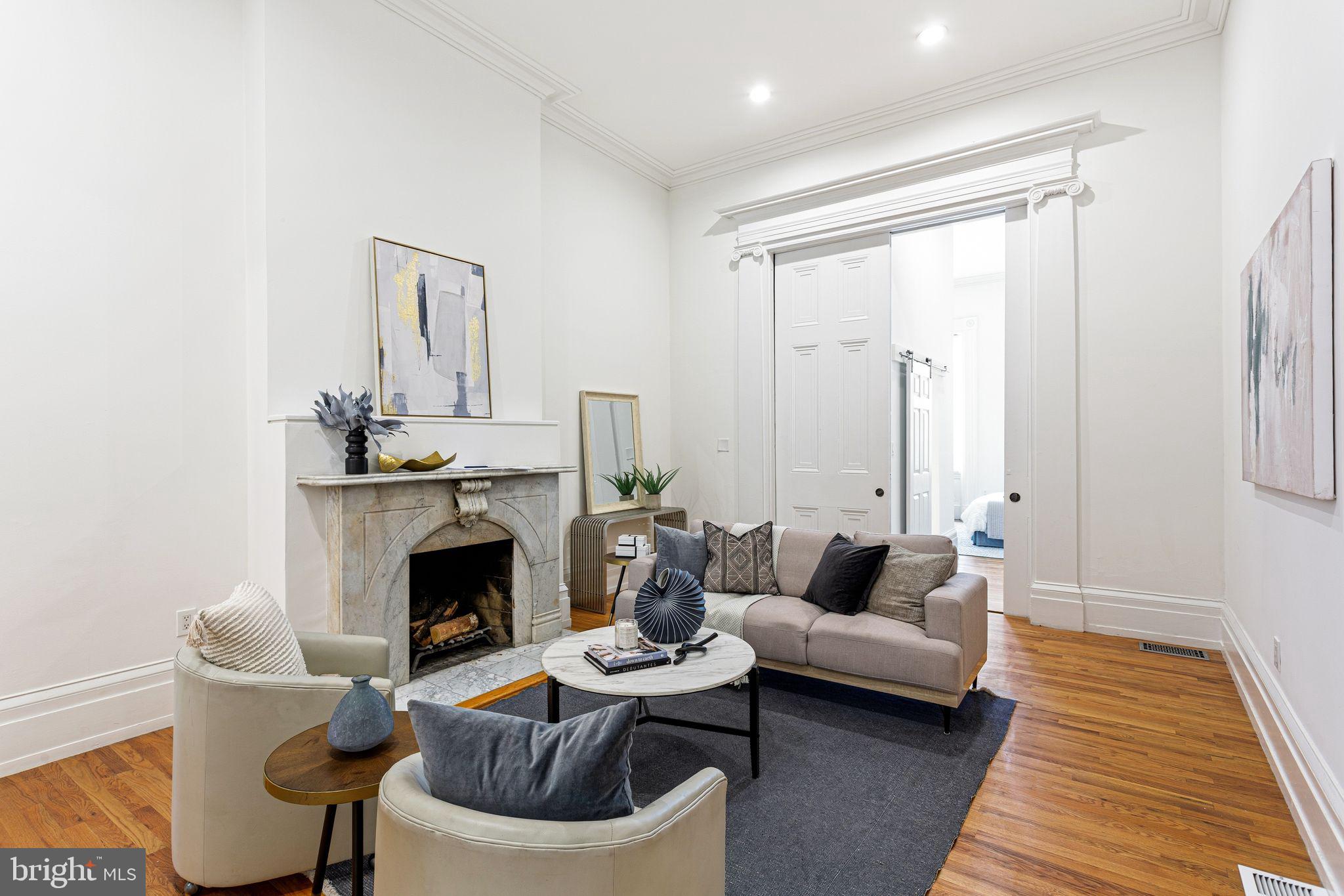 3 units left in this exclusive building, incredible location! Step into a seamless blend of historic charm and modern luxury in this beautifully renovated residence, set within an elegant 1800s brownstone in the heart of Washington Square West. Rich in character and architectural detail, this exceptional home features soaring ceilings, an original working marble fireplace, and the rare convenience of parking.
 

A grand double-door foyer welcomes you into a thoughtfully designed space where timeless craftsmanship meets contemporary sophistication. This ground-floor residence at 306 S 10th Street boasts impressive 15-foot ceilings, hardwood floors, and tastefully updated bathrooms, including a glass-enclosed shower in the primary suite.  Period details—including crown molding, a restored original column, and an oversized pocket door—have been carefully preserved and paired with modern upgrades like granite countertops, a spacious kitchen island, stainless steel appliances, and a wine fridge.


Standout features include rare two-car gated parking, a private outdoor space with a charming brick courtyard complete with hose hook-up, and generous closet storage throughout. Sunlight pours into each spacious bedroom through oversized windows, creating a bright and inviting atmosphere.


Additional amenities include Nest thermostats, smart keyless entry with video intercom and phone access, a security system, in-unit washer and dryer, custom blinds, and private basement storage. The building also benefits from a newly installed main roof with strong warranties for added peace of mind.
 

Ideally located in a “Walker’s Paradise” and “Rider’s Paradise,” this home offers easy access to everything Center City has to offer. PATCO lines are just a short walk away, along with neighborhood favorites like Seger Park and Palumbo Playground. Convenient to Pennsylvania and Jefferson Hospitals and located within the desirable McCall School catchment, this home is perfectly suited for both professionals and families.


306 S 10th Street #A presents a rare opportunity to own a move-in-ready residence that beautifully balances historic elegance with modern comfort. A 3D Matterport tour is available for a closer look. The seller is also offering a 1% interest rate buy-down for the first year at no additional cost when using their preferred lender, along with a one-year prepaid home warranty.