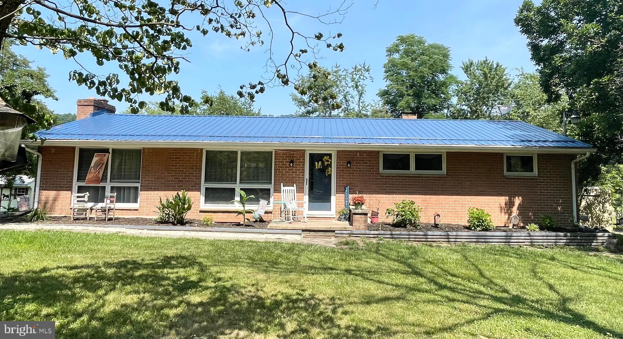 Classic rancher with land!!!  This brick rancher is a country charmer on over 4 acres.  The front yard is delightfully landscaped with a large horseshoe driveway around the home.  The acreage is great for the family, hunting, pets, or even farm life.   The family room has been converted into a spacious bedroom but can be converted back easily to suit your lifestyle.  Head downstairs to more finished square footage, a bedroom, tons of storage and workshop/laundry space.  Did I mention a new metal roof???!!!!!