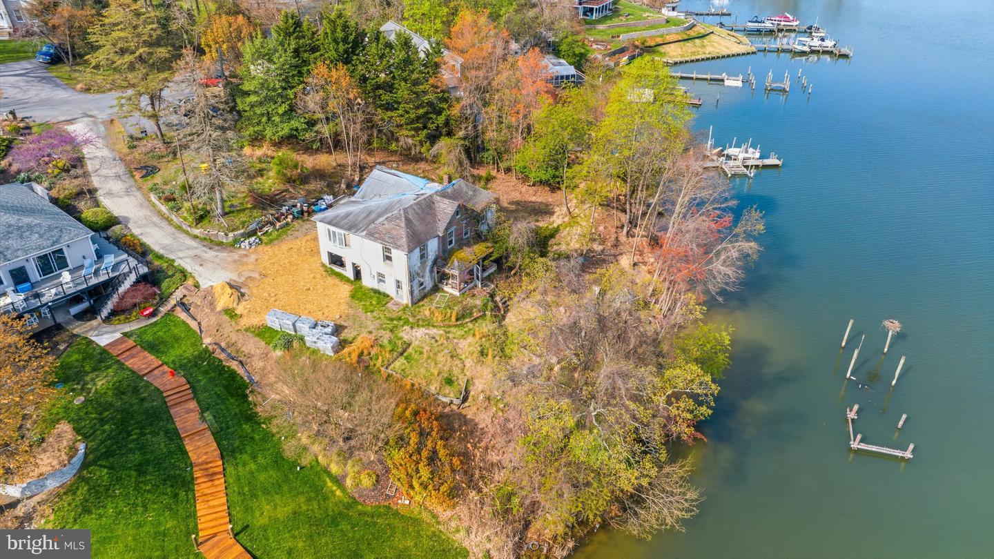 An exceptional opportunity to secure a waterfront lot in one of Pasadena’s most desirable settings. The existing home requires renovation or redevelopment, offering a blank slate to create a custom residence tailored to your vision. Now listed with a house to be built by Caruso builders. You can adjust the type of house you want reach out to us or to your agent for more information. Imagine designing your ideal waterfront retreat with sweeping views, private access, and space to entertain—all just minutes from Annapolis and Baltimore. Bring your builder and your vision—opportunities like this are rare. This is more than a lot or a home—it’s a lifestyle.TO BE BUILT NEW CONSTRUCTION. Beautiful lot Co- Marketed with Caruso Homes. This Model is the ---- SEAHAWK --- The Seahawk is a stunning waterfront home designed for breathtaking views. It starts at 2,922 sq. ft., expandable to 4,179 sq. ft., with an open main-level floor plan. Customize with upgrades like a gourmet kitchen, sunroom, flexible office or in-law suite, and decks on every level. Multiple second-floor layouts let you tailor the home to your family, while an optional third-floor loft and deck add even more space for entertaining or relaxing at sunset. --- Buyer may choose any of Caruso’s models that will fit on the lot, prices will vary. Photos are provided by the Builder. Photos and tours may display optional features and upgrades that are not included in the price. Final sq footage are approx. and will be finalized with final options. Upgrade options and custom changes are at an additional cost. Pictures shown are of proposed models and do not reflect the final appearance of the house and yard settings. All prices are subject to change without notice. Purchase price varies by chosen elevations and options. Price shown includes the B The seller agrees to credit to the purchaser, at settlement, $ 50,000 for site improvements toward buyers' development expenses and can be used toward any waterfront, or landward improvements. ase House Price, The Lot and the Estimated Lot Finishing Cost Only. Builder tie-in is non-exclusive.