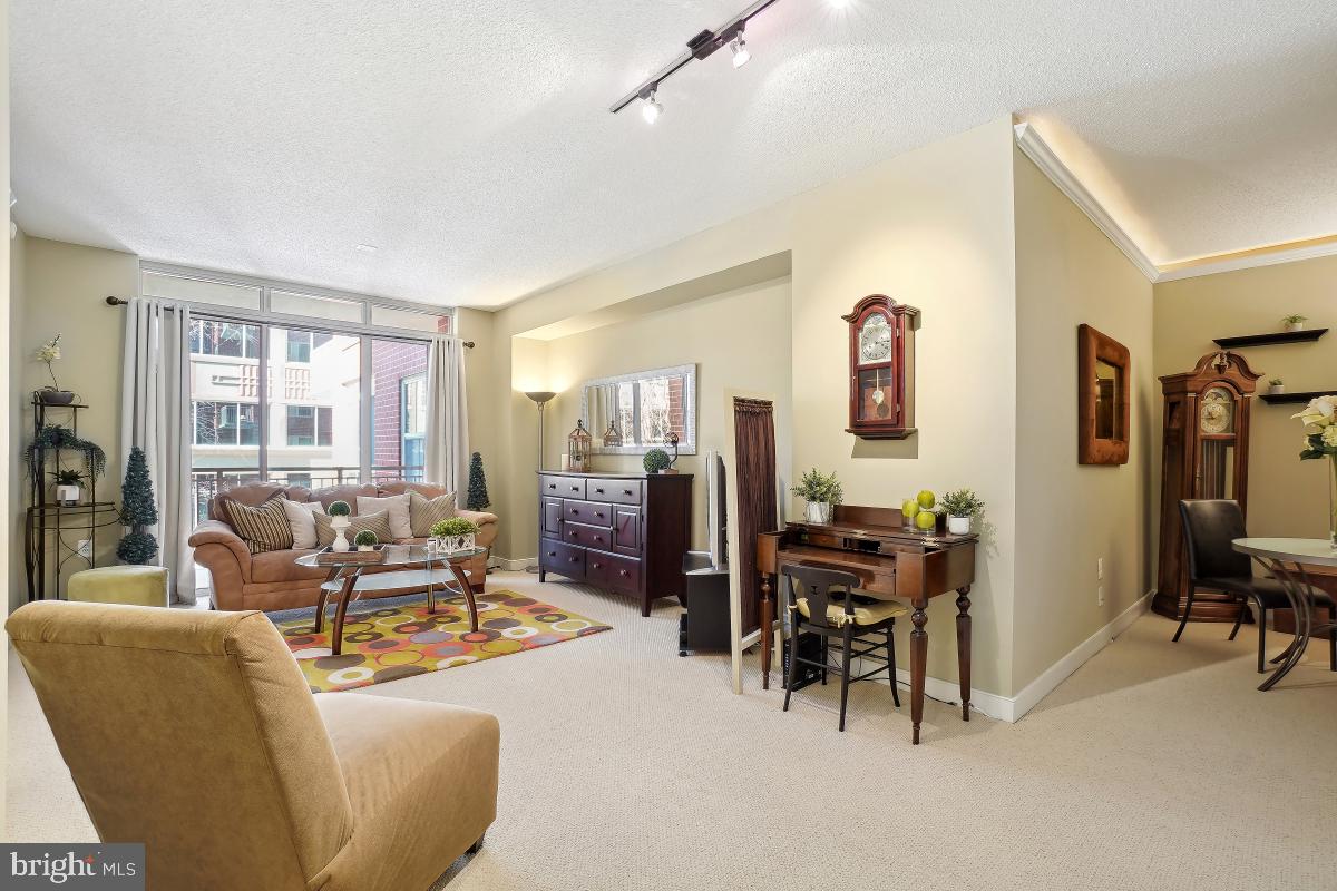 In the heart of all that is wonderful about Arlington! Walk to Metro,  Northside Social, so many restaurants and shops! Also close to Whole Foods and Everything Arlington! Fabulous One Bedroom PLUS DEN - and Balcony - AND Garage Parking! Shows beautifully - tastefully done. Open living room leads to balcony which overlooks courtyard and trees! Den off living room - could be used for office or dining area! Elevator building with fitness center, business center. Perfect move in condition - lightly lived in and perfectly maintained.  Open Sunday 1-3.
