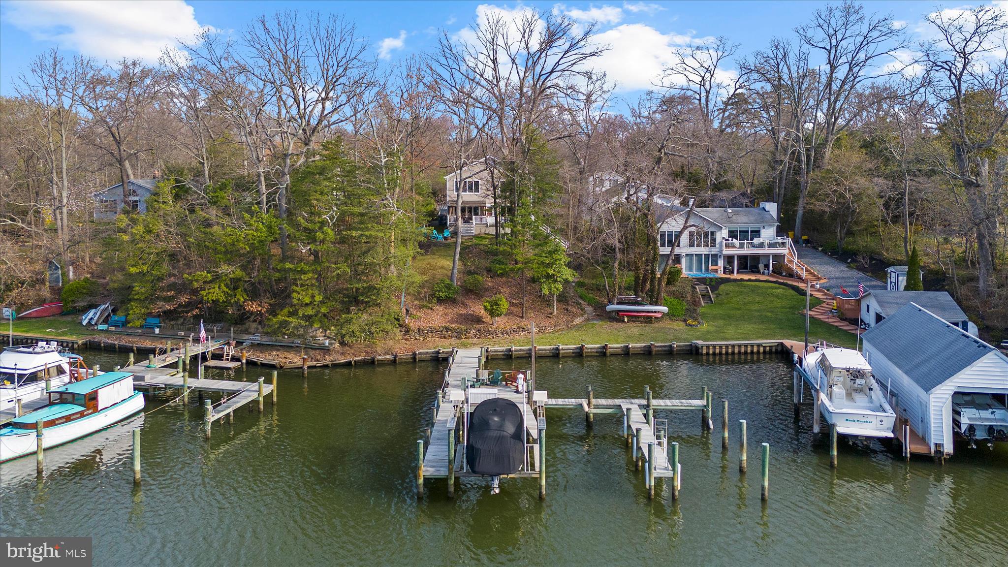 **Offer Deadline Monday, 4/6 @5PM** Experience the best of waterfront living in Lower Magothy Beach. Set on nearly an acre with beautiful views of Cattail Creek, this spacious custom home is filled with natural light and thoughtfully designed for everyday living and effortless entertaining. The home features five generously sized bedrooms and four full baths, including a convenient main-level bedroom and full bath. The open floor plan offers expansive living and dining spaces, enhanced by new LVP flooring installed over the original wood floors. The updated gourmet kitchen features a large center island, stainless steel appliances, and seamless flow into the family room, where water views take center stage and access to the waterside deck creates easy indoor-outdoor living. 

The newly renovated lower level adds even more flexibility, with a spacious entertainment area, an additional bedroom, a full bath, a home gym, and a private entrance. Ideal for guests, multigenerational living, or an au pair suite, it offers both comfort and privacy. 

Outside, the waterfront amenities truly shine. The private dock, rebuilt in 2017, offers three boat slips, an electric boat lift, and a dedicated launch area for kayaks and paddleboards. Deep, navigable water provides easy access to the Magothy River, making days on the water simple and enjoyable. Back at home, relax on the expansive deck, gather around the custom firepit patio, and take advantage of storage sheds and dedicated rack space for kayaks, canoes, and paddleboards. An oversized driveway provides plenty of room for vehicles, equipment, and all the extras that come with waterfront living.

Located within the Severna Park school system and just minutes from shopping, dining, and major commuter routes, 311 South Drive offers a rare opportunity to enjoy a private waterfront setting with exceptional space, flexibility, and waterfront amenities.