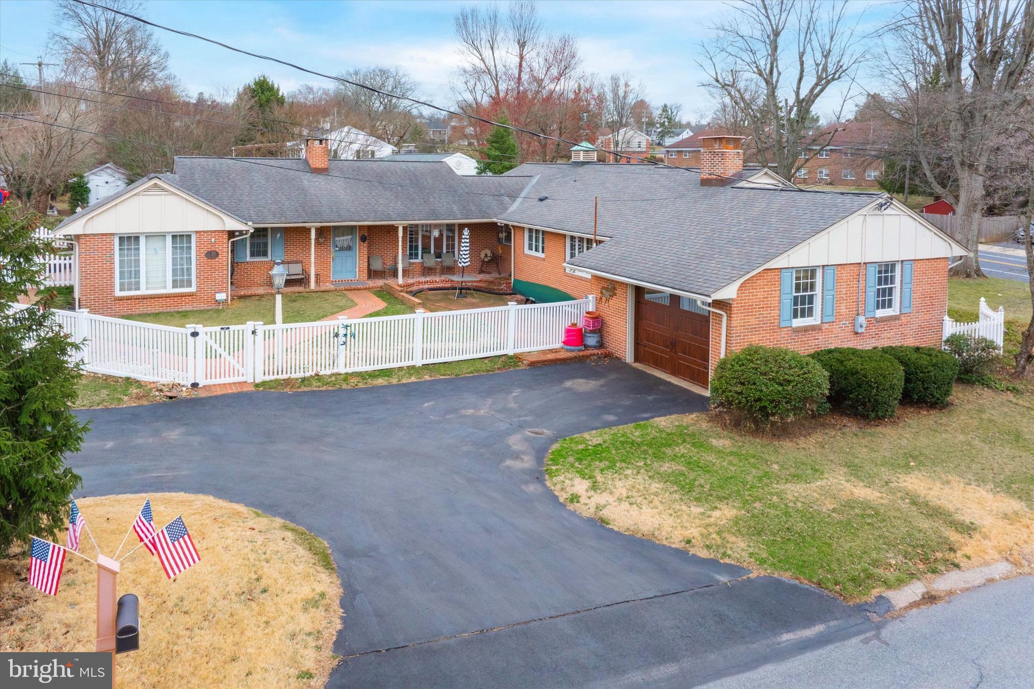 Situated at 203 Chestnut Street in Birdsboro, this charming single-family home boasts 4 bedrooms, 2 full bathrooms, and over 3,000 square feet of living space on a 0.33-acre lot.   Meticulously maintained, this residence is a must-see, showcasing exceptional quality and craftsmanship throughout its spacious and versatile layout, ideal for multi-generational living or entertaining guests.   Its adaptable floor plan allows for various living arrangements, including the possibility of guest suites or in-law quarters.
The ranch-style design features a generous living room complete with built-in bookshelves and a double-sided brick fireplace.  The original dining area is now a great receiving room and the kitchen is outfitted with an electric cook top, double sink, custom solid oak cabinets and a window overlooking outside, keeping it’s original charm.  Continue your tour as you step into the dining room,  featuring beautiful hardwood floors and an abundance of natural light. Then,  proceed to the side entry foyer that guides you to the second kitchen.   This updated kitchen boasts tiled flooring, a wall oven, a wall microwave, and a gas oven, leading to an outdoor exit with French doors that open onto a charming brick patio. The kitchen features a breakfast bar that seamlessly opens into the additional living room.  All the bedrooms are conveniently located on the main floor, featuring a primary bedroom with an en suite bathroom.  Addiitonal 3 bedrooms and another full bath. One of the bedrooms boasts new flooring.
The lower level is a dream come true for hobbyists, crafters, or collectors, showcasing a partially finished 45' x 23' storage area, a cozy family room with a wood-burning stove, and multiple workshop spaces complete with built-in cabinets, shelving, and glass display cases. This level features a spacious laundry room equipped with a laundry sink and ample cabinetry for storage.  Don’t miss the spiral staircase!
Enjoy a fenced yard and lovely brick walkways with ample outdoor spaces to unwind! 1 Car garage with inside access to the main house and the lower level.  Don't let this amazing opportunity slip away— there's more to tell, but best to get inside to see it for yourself!