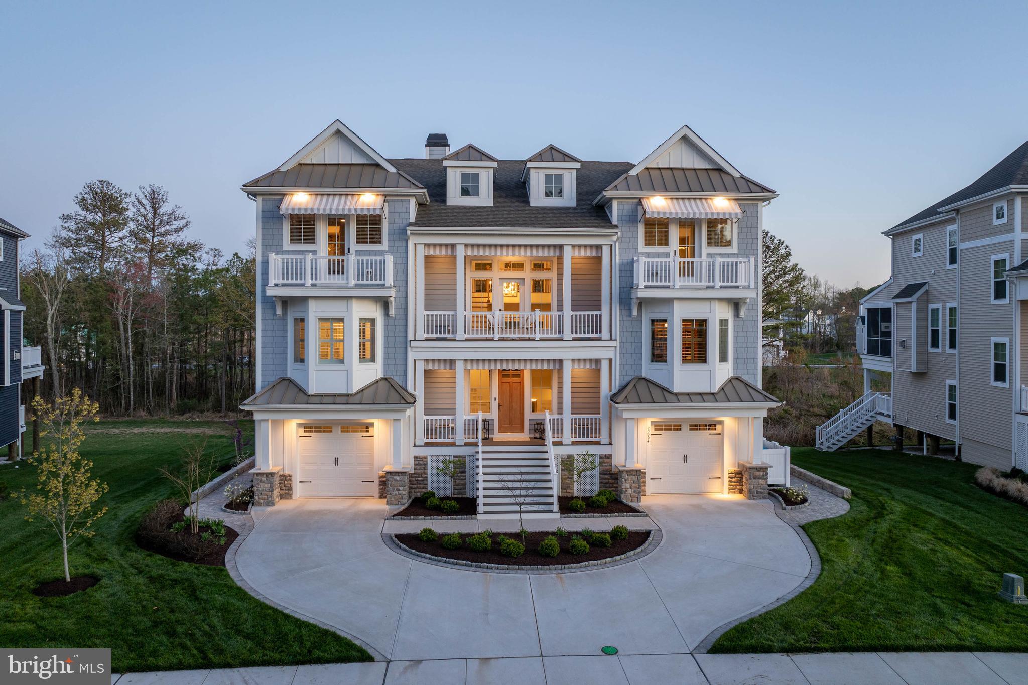 HIGH-END CUSTOMIZATION MEETS COASTAL PERFECTION in this Marsh Island Estates masterpiece that far transcends standard builder grade. Wrapped in premium Hardi-Plank fiber cement siding for ultimate durability, this 5-bedroom, 5.5-bathroom estate redefines luxury across three levels of meticulous upgrades. The exterior sets a grand tone with a circular paver-bordered driveway, Belgium block curbing, and high-performance Andersen windows featuring warm wood interiors and weather-resistant vinyl exteriors. Inside, the home makes a lasting impression with soaring 8-foot solid core interior doors and a two-story coffered ceiling Great Room anchored by a floor-to-ceiling stone natural gas fireplace and premium engineered wood flooring.

The culinary space is a designer’s dream, boasting quartz countertops, a breakfast bar, and a sophisticated custom pantry scullery. No expense has been spared in the bespoke interior, from the custom Ralph Lauren fabric window seat in the library to the designer wallpaper and mirrors in the powder room. The main-level primary suite serves as a true sanctuary with custom closet systems and a spa-inspired marble tiled bath, while the top floor hosts three additional bedrooms, each with en-suite baths and walk-in closets. High-tech enhancements abound, including a comprehensive security system, surround sound, Hunter Douglas treatments, and tinted rear windows for solar protection.

Outdoor living is truly unrivaled, featuring a rear paver patio with a built-in fire pit and an expansive screened porch enclosed with an EZE Breeze window system for year-round enjoyment. Multi-level decks offer panoramic vistas of the surrounding wetlands and Love Creek, which leads directly to the Rehoboth Bay. Residents enjoy immediate water access via a community boardwalk and pier system. This is not just a home; it is a meticulously curated retreat where every detail, from the epoxy-finished garage floors to the architectural-grade finishes, provides a living experience far superior to any standard construction. Contact us today to experience this coastal crown jewel in person!