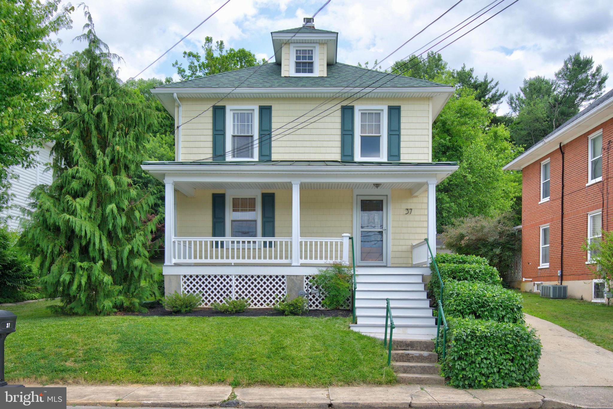 This darling 1923 home is full of surprises!  While the charm of yesteryear is solidly intact, the changes over the years make this a unique home with more room than you'd expect. Inside the home, you'll find a modern kitchen with newer appliances, as well as living and dining rooms with original hardwood floors.  What you might not expect is the beautiful family room at the rear of the house - with a fireplace, a half bath, built-ins, and a gorgeous view of the back yard!  Upstairs, the 3 guest rooms and full bath may be just what you expected, but the master bedroom is a very pleasant surprise!  There is an additional room on the 3rd floor that could be an office, TV room, bedroom, or getaway; it just needs heat/AC to be finished space.  The basement has been well-maintained and features a laundry area right at the bottom of the steps.  Out the back door, you'll find a tranquil oasis, complete with shade trees, mature plantings, fish pond, brick patio, and a rock waterfall - idyllic!  The maintenance-free front porch is the perfect place to sit and enjoy small town life. You won't have to compete for street parking here, as there is a concrete driveway beside the house, leading to a 2-car tandem garage.  And that garage has a full second floor, just right for a studio of any kind!  Don't judge this book by its cover - it is a charming 1920s Colonial, but so much more!