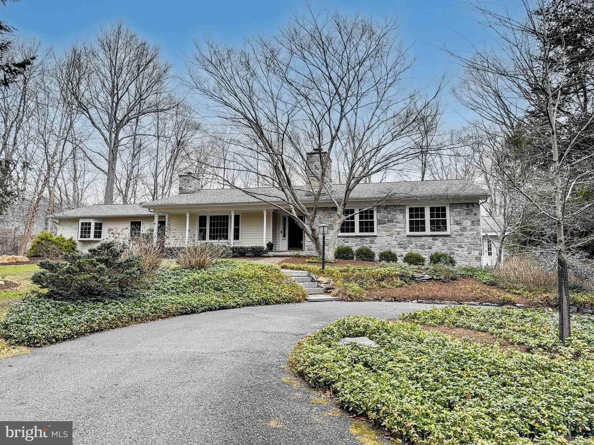 Welcome home to 1304 Old Forge Road in Oxford PA, a stunning custom stone ranch home nestled on 5.2 beautiful acres overlooking the Big Elk Creek. This warm and inviting home has been thoughtfully updated to include many high-end finishes and custom features which give it a casual, yet elegant feel. Highlights include a warm and inviting living room with hardwood floors, a beamed ceiling, built-in bookshelves and large picture window. French doors lead to the spacious dining room, with a large bay window offering beautiful views of the pool and woodlands to the rear of the home.  The custom kitchen was designed by Waterbury Kitchens in Chadds Ford and is a chef’s delight, with a 6-burner professional Viking Stove, upgraded SS appliances, a large island perfect for food prep and casual dining, highlighted by a large bay window offering beautiful views of the pool and rear patio area.  There is a private study with custom wood paneled walls and stone, wood burning fireplace, perfect for a home office or cozy den. The home was expanded by Cedar Knoll Builders to include the addition of a large “owners wing” which includes a private bedroom suite and spacious sitting room with vaulted ceiling, exposed stone wall and a large sliding glass door which leads to the pool area.   The primary bedroom has a cathedral ceiling, gas fireplace and bay window with yet another beautiful view of the pool. The ensuite bathroom and dressing area includes dual sinks and large closets, a separate bathing area with radiant floor heating, claw foot tub, walk around shower and water closet. Opposite the owner’s wing, there are two more spacious bedrooms, one with an ensuite bath and walk-in closet, and another with built-in bookshelves.  A renovated hall bath completes the right wing of the home. The finished lower level can be accessed by two separate staircases and includes a large rec room with wet bar/mini kitchen, (think circa 1980), a powder room, a spacious fitness room with tall ceilings  perfect for large gym equipment, and a home theater room.  The roof was replaced in 2023.  Outside, to the rear of the home, you will find a stunning Anthony Sylvan pool with an expansive multi-level deck with pergola, an outdoor fireplace and a beautiful cabana building with beamed cathedral ceiling and TV    perfect for outdoor entertaining.  For the home gardener and casual farmer, there is a large, fenced vegetable garden with raised beds and a custom hen house with running water. If you love to fish, simply walk the path through the backyard to the stocked Big Elk Creek and drop your line in! Make your appointment today, this unique and special home will not last long!