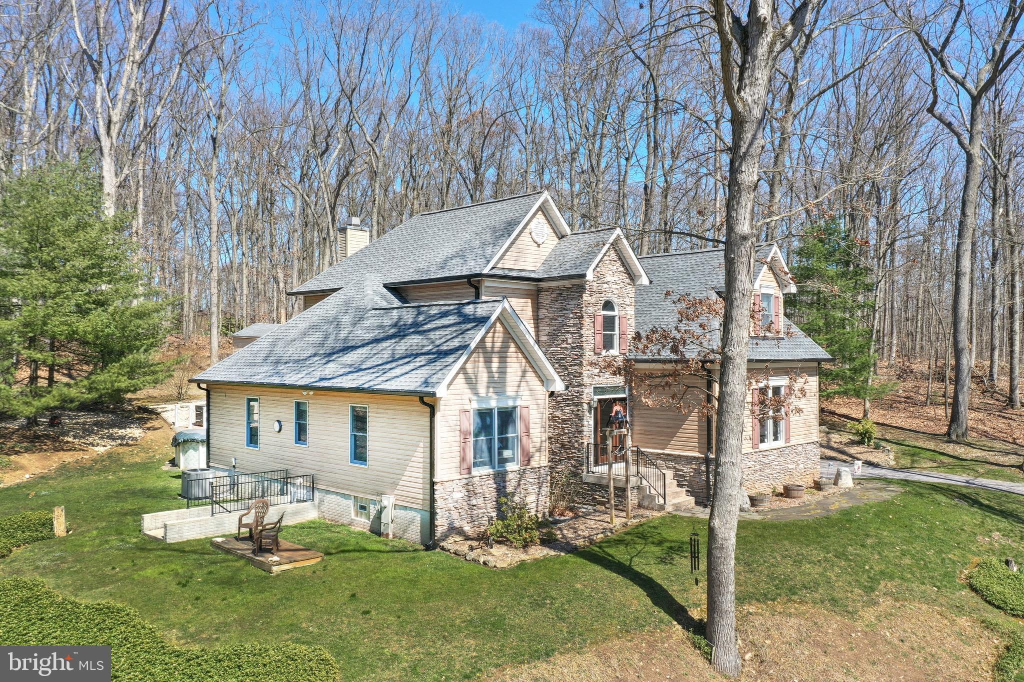This beautifully renovated Craftsman Colonial offers over 4,500 square feet of open and inviting living space, seamlessly blending modern amenities with timeless charm, expansive indoor and outdoor entertaining areas, delightfully nestled on 3.33 acres of private land! Inside, large windows illuminate a welcoming foyer and two-story family room with stunning stone fireplace, creating a bright, inviting atmosphere perfect for relaxing or hosting guests. The custom kitchen features granite countertops, high-end appliances, and a spacious snack bar overlooking a sunny breakfast nook, den and sitting room areas opening to the awesome paver patio, fire pit area and pool deck for easy transitions outside. Opposite the great room, two bedrooms served by a full bath complete the first floor. The second floor reveals a loft area overlooking the great room, a fantastic primary retreat with generous walk-in closet, abundant natural light and custom bath boasting oversized walk-in tiled shower, double vanity, window seat and high-quality appointments. An additional second-floor bedroom presents a flexible space ideal for a nursery, professional office, fitness, hobbies and more. Downstairs, the full walk-out basement includes a huge recreation room and third full bath, plus ample storage area with option to add future living space if desired. Step outside to enjoy the peaceful wooded setting, which provides the perfect backdrop for your outdoor oasis, featuring a picturesque paver patio, fire pit, above-ground pool, picnic areas, and plenty of room to run, play and enjoy nature. Every detail has been carefully designed for the utmost comfort and style, meticulously renovated and maintained top to bottom, including a new, energy-efficient HVAC system, and new roof, so you can move right in with peace of mind, knowing your home is well-protected.  Great serene and private location, but close to amenities, hospitals, and easy access to I-83, for a quick commute to Baltimore and York PA. Don’t miss this opportunity to own a little slice of heaven! Schedule your showing today!