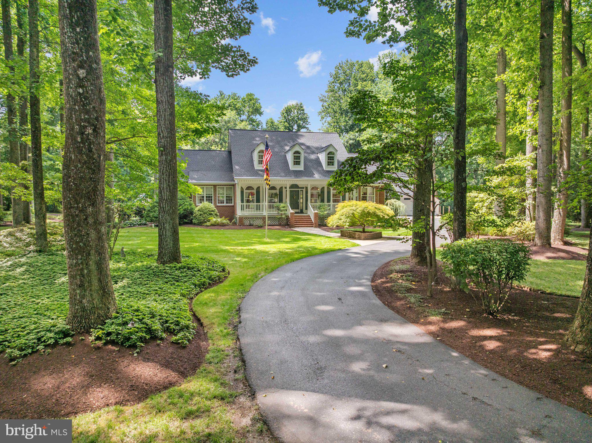 Welcome to Tall Oaks, where privacy, luxury, and outdoor living come together on one of the community’s most desirable lots. Nestled at the end of a quiet cul-de-sac on 2 picturesque acres, this fully brick oversized Cape Cod  offers breathtaking views, unmatched tranquility, and a peaceful setting that’s hard to find. From the moment you enter the tree-lined streets of Tall Oaks, you’ll appreciate the beauty and charm of this sought-after neighborhood. Pulling into the driveway, you’ll be greeted by lush landscaping, mature trees, and stunning curb appeal highlighted by a welcoming front porch and timeless brick architecture. Designed for both everyday living and entertaining, the backyard is truly a showstopper. Enjoy your own private oasis featuring extensive paver walkways, a large patio, screened porch, outdoor shower, and an impressive covered wet bar with a peaked roof—perfect for hosting gatherings or relaxing while taking in the serene surroundings.
Inside, you’ll find over 5 bedrooms, 3 full baths, and 2 half baths with plenty of room to spread out. The main-level primary suite is a luxurious retreat featuring a walk-in closet, heated bathroom floors, and a spa-inspired steam shower. The main level also offers a private office, formal dining room with hardwood flooring, and an expansive eat-in kitchen complete with granite countertops, 42” cabinetry, and abundant workspace. The spacious family room showcases a stunning stacked-stone fireplace and two sets of French doors leading directly to the backyard, seamlessly blending indoor and outdoor living. Upstairs, you’ll find three generously sized bedrooms, two full bathrooms, and ample storage space. The fully finished lower level provides even more versatility with an additional bedroom, full bath, and plenty of room for recreation, guests, or multigenerational living. Additional features include a detached oversized two-car garage with a dedicated workshop area, abundant parking, a roof and oversized gutter system replaced just three years ago, and an HVAC system with propane backup installed approximately six years ago. This is the rare property that truly checks every box—privacy, space, upgrades, outdoor living, and an incredible setting—all already done for you. Welcome home.