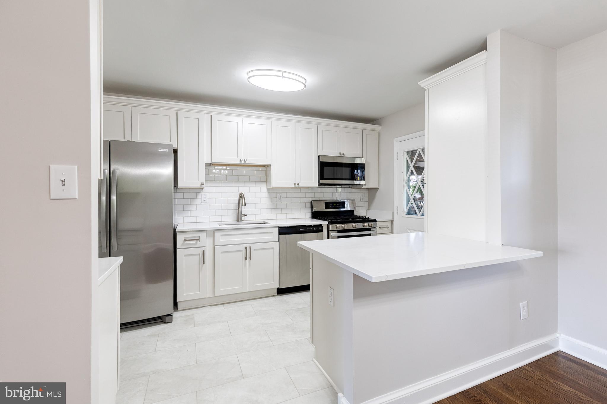 Welcome to 5649 Utrecht Rd., a beautifully renovated home where nearly every surface has been thoughtfully updated to create a space that feels both timeless and completely move-in ready. From the gorgeous refinished hardwood floors to the fully redesigned kitchen and fresh finishes throughout, the amount of work poured into this home is immediately evident the moment you walk through the door.

One of the standout features is the completely reimagined main level. Unlike many homes in the community, the wall between the kitchen and dining area was opened to create a seamless open-concept layout that completely transforms the flow of the home. Whether entertaining guests or enjoying everyday life, the space feels bright, functional, and connected.

The kitchen was fully renovated with classic white shaker-style cabinetry, quartz countertops, white subway tile backsplash, stainless steel appliances, updated lighting, a charming coffee bar area, and a large island with seating and additional storage below and beautiful LVP flooring,  truly the heart of the home.

Professionally refinished hardwood floors run throughout the first and second levels and pair beautifully with the custom stained staircase and freshly painted banister. Recessed lighting and updated fixtures throughout the home give every space a warm and elevated feel.

Upstairs offers three generously sized bedrooms with ample closet space along with an updated bathroom featuring a new vanity, mirror, and lighting.

The finished lower level offers incredible flexibility and can function as a rec room, guest space, home office, gym, or potential fourth bedroom setup. Brand-new LVP flooring, fresh paint, and a newly coated utility/storage area make the basement feel fresh, bright, and usable from day one.

Outside, enjoy the covered rear porch with built-in seating overlooking the fully fenced backyard, along with the convenience of a private two-car parking pad.

Recent updates include roof replaced in 2023, brand-new sump pump in 2026, brand-new basement windows in 2026, brand-new front door in 2026, new front walkway and entry stairs in 2026, fresh paint throughout, refinished hardwood flooring, new recessed lighting and fixtures throughout, and extensive kitchen and basement renovations completed in 2026.

Conveniently located near I-95 and I-695 with easy access to shopping, dining, and commuter routes.

Schedule your private showing today.