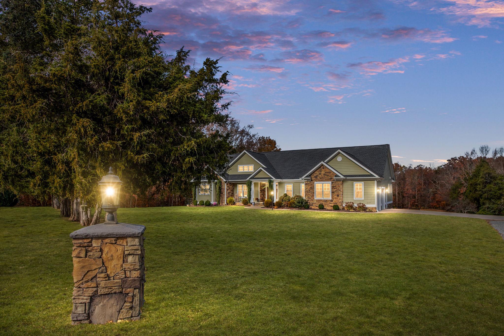 Experience the perfect blend of privacy, craftsmanship, and convenience in this stunning custom Craftsman-style ranch offering nearly 6,000 square feet in sought-after South Stafford. Set on approximately 14 picturesque acres protected by a conservation easement, this exceptional property offers the peaceful setting buyers dream of without sacrificing accessibility. A long private driveway winds through to the property, creating a secluded retreat surrounded by large parcels and neighboring conserved farmland.

A welcoming covered front porch invites you to relax and take in the sunrise before stepping inside to a light-filled foyer accented by exotic cherry hardwood flooring. The spacious living room features soaring vaulted ceilings, a double-sided fireplace, and expansive Pella windows that frame breathtaking seasonal views and abundant wildlife.

Designed for both everyday living and entertaining, the gourmet kitchen features an oversized island, upgraded granite countertops, premium gourmet appliances, and custom solid wood Hagerstown Kitchens cabinetry. A butler’s pantry provides seamless flow into the dining room, while the screened porch offers the perfect setting for outdoor dining and relaxing summer evenings. The main level office with custom built-ins provides an ideal work-from-home space while blending beautifully with the home’s craftsmanship and design.

The luxurious primary suite serves as a private retreat with French doors opening to a personal balcony overlooking the property. Dual walk-in closets provide ample storage, while the spa-inspired bath features a freestanding soaking tub, double vanity, and an oversized fully tiled shower with dual showerheads.

The thoughtfully designed walkout lower level is filled with natural light thanks to its fully above-grade rear wall and abundance of windows. Complete with a kitchenette, sit-up bar, family room, three bedrooms, and two full bathrooms, the lower level offers ideal flexibility for multigenerational living, guests, or extended stays. Nearly 700 square feet of unfinished storage, including a separate concrete room, provides endless possibilities for a future wine cellar, safe room, workshop, or hobby space.

Outside, enjoy wooded acreage with private trails leading to Little Falls Creek. The maintenance-free rear deck overlooks the scenic landscape, creating the perfect backdrop for enjoying Virginia’s natural beauty year-round. The whole home backup generator provides additional peace of mind for any unexpected power disruptions year-round.

Conveniently located just minutes from Downtown Fredericksburg, Little Falls Boat Ramp, McDuff Green Park, and Ferry Farm, this extraordinary property also offers easy access to Quantico, Dahlgren, Richmond, Washington DC, and the Downtown Fredericksburg, Leeland, and Brooke VRE stations.

This is a rare opportunity to own a quality-built custom home with breathtaking views from nearly every window.