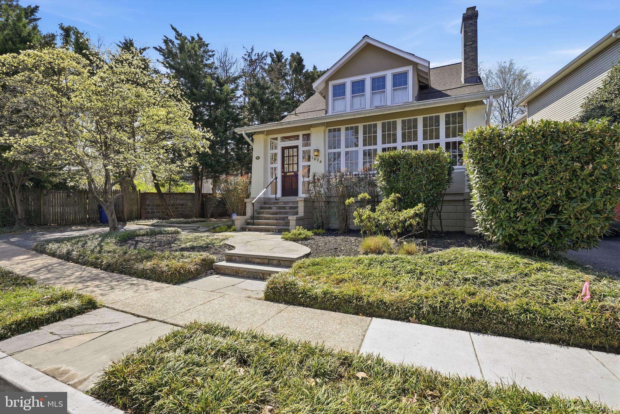 Located in sought-after Lyon Village, this historical 1915 Arts and Crafts bungalow is rich with the character, warmth, and charm of a bygone era, but fully modern for life in 2026.   Thoughtfully maintained, this home showcases the hallmark details of the era:  warm hardwood floors, original millwork, a glass-enclosed room, and abundant natural light that fills the home throughout the day.  
Spanning approximately 2,400 square feet, the home features 4 bedrooms and 3 baths, including a generously sized primary suite with two walk-in closets. Each bedroom offers ample closet space and flexibility for a variety of uses, whether as a home office, study, or hobby space.
The updated kitchen blends timeless style with everyday functionality, offering quality cabinetry, granite counters, and a well-designed, efficient layout. Positioned between the family room and formal dining room, it supports a natural flow throughout the main living spaces. The large family room is warm and inviting for everyday living, while the dining room provides an elegant setting for entertaining.
The lower level, typical for a home of this age, offers valuable storage and houses the home’s systems, adding to the overall functionality of the home.
Surrounded by beautiful, landscaped grounds with mature plantings, the outdoor setting offers both privacy and a peaceful retreat. It is an ideal space for relaxing or simply enjoying the natural surroundings.
This home, located in the heart of Clarendon, offers an exceptional lifestyle where convenience meets urban living, wrapped in a sense of Arlington’s past.  Step outside to enjoy morning coffee at a favorite café, an evening at one of the area’s celebrated restaurants, or a quick commute via the nearby Metro. With its dynamic energy, green spaces, and neighborhood charm, Clarendon offers a setting that feels both vibrant and effortlessly livable.
