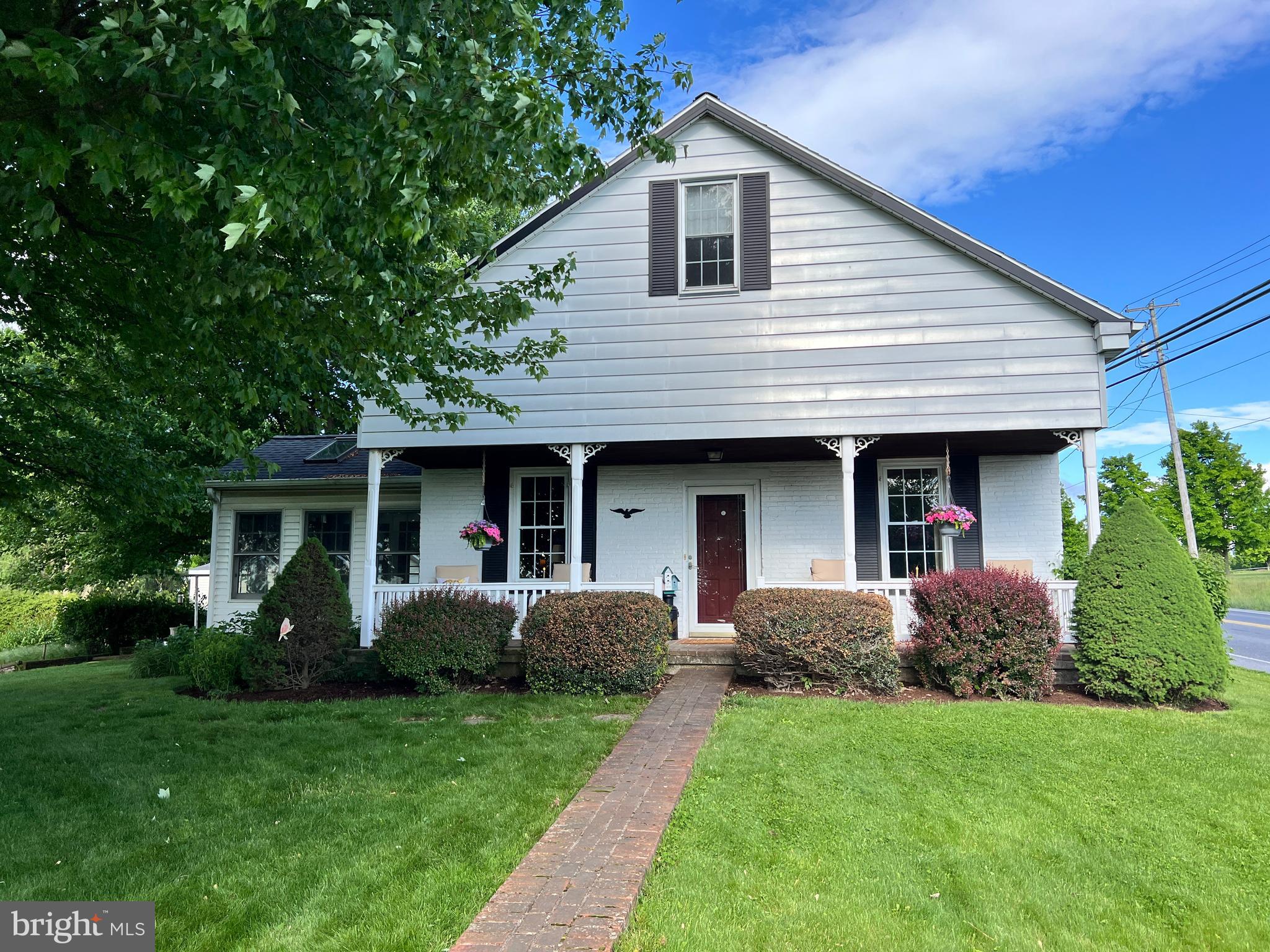 This property will be offered at Public Auction on Thursday, June 25, 2026 @ 6pm.  The listing price is the opening bid only and in no way reflects the final sale price.  10% down due at auction, 2% transfer tax to be paid by the purchaser, real estate taxes prorated. Nestled in a peaceful setting with beautiful country views, mature trees, and perennial flowers throughout the property, this charming home offers comfortable living spaces along with unique outdoor amenities perfect for relaxing or entertaining. The main level features a spacious eat-in kitchen, a convenient mudroom/entryway with laundry area, a full bathroom, a bedroom, a flexible bedroom or office space, and a bright sunroom that provides additional living space and scenic views of the surrounding property. The second floor includes an additional bedroom with expandable space offering future potential, while the unfinished basement with concrete floors and a wood stove with floor registers provides extra storage or workshop space. Additional amenities include an original cozy cabin-style playhouse with a firepit area, a storage barn, an enclosed back porch, and a detached 3-car garage with running water. A special piece of local history is tied to the property, as this former schoolhouse once housed the original Doe Run School bell, which was later donated to Doe Run Elementary School across the road, where it remains on display today. Whether you are looking for a weekend retreat, starter home, or peaceful country getaway, this property offers plenty of potential and so much to enjoy.