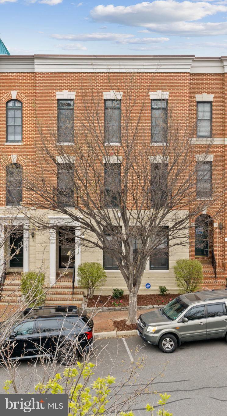 Welcome to this beautiful traditional Brownstone townhouse tucked along a peaceful, tree-lined street with a charming, old-town feel, just steps from the marina and town center. Offering over 3,000 square feet across three fully above-grade levels, this light-filled home combines space, flexibility, and modern updates.

The entry level features a welcoming foyer, a spacious third bedroom with a full-size window and closet, a full bath, and an expansive media/recreation room spanning the entire rear of the home. The space flows seamlessly to the two-car garage, complete with newly finished flooring and freshly painted walls and trim, plus two additional driveway parking spaces.

The main level showcases an open-concept layout ideal for everyday living and entertaining. The kitchen is fully updated with brand new stainless steel GE appliances, including a refrigerator with door icemaker, double wall oven with top convection oven, gas  cooktop, dishwasher, and built-in microwave. The kitchen opens to a large family room with a gas fireplace and access to an oversized terrace—perfect for outdoor enjoyment. A formal living and dining area, along with a convenient half bath, complete this level.

Upstairs, the bedroom level offers two generously sized primary suites, each with its own full bath, ample closet space, and abundant natural light from large windows.

Located in the sought-after Belmont Bay waterfront community, residents enjoy proximity to the Occoquan River, marina, and nearby shops. Convenient access to the VRE and just a short drive to historic Occoquan adds to the appeal of this exceptional home.