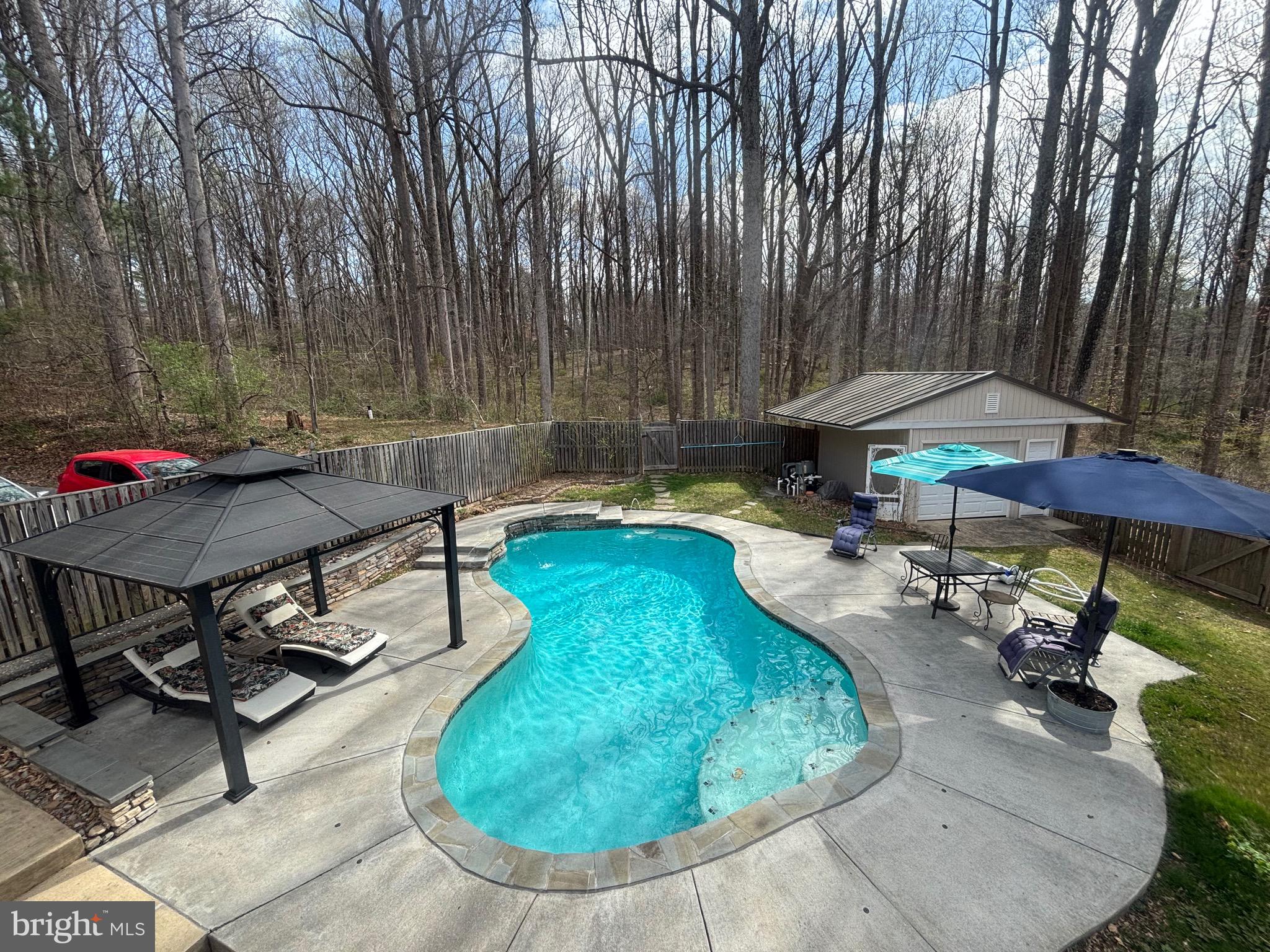 Welcome Home to 7491 Mink Hollow Rd, a true sanctuary located in the beautiful, serene Highland Community nestled within the highly sought-after Howard County. This spacious 6-bedroom, 5-bathroom residence offers an exceedingly rare 6,402 SQFT of luxurious living space, providing a unique opportunity to own a private retreat in this desirable area.

Set back from the street, the home offers unparalleled privacy and tranquility, making it an ideal escape from the hustle and bustle of everyday life. Recently refreshed in 2025, the property boasts new paint in specific areas ensuring a move-in ready experience for the discerning buyer.

Thoughtfully designed with both comfort and functionality in mind, the residence features well-proportioned and interconnected living, dining, and family rooms, creating an ideal flow for daily living and entertaining.  This home is very energy efficient and benefits from an abundance of natural light, and the generous room sizes offer a seamless transition between formal and casual spaces. The chef's kitchen, complete with quartz countertops and high end appliances, adjoins a family room and the main dining room.

The main level features the primary oversized bedroom suite, with ample closet space and a renovated en-suite bathroom with a jetted tub.  Upstairs, discover 4 more bedrooms with closets, 2 full bathrooms. 

The nearly 2000 SQFT lower level provides access to the attached private-car garage and includes a private suite with a separate kitchenette, laundry and spacious family room. This space is perfect for guest accommodations and an au pair suite. The property also features three distinct outdoor spaces, including a hardscaped back patio, a spacious side yard, and an oasis in the front, perched high above the street and surrounded by mature foliage.  Let's not forget about the heated pool that was constructed in 2016, creating its own ambiance with the Chiminea and outdoor features for a grand time with family and friends. The lower space that is currently being used as an office can be converted into a 7th bedroom as there is an adjoining closet space next to the full bath.

Homes of this size on such expansive land are rarely available, offering a unique opportunity to own a sizable estate in Howard County's Highland Community. The property is conveniently located with access to major commuting routes and is close to top-rated schools namely River Hill High, Lime Kiln Middle and Dayton Oaks Elementary.  The ease of access to shopping centers, and local amenities are within minutes of travel time. Enjoy the best of both worlds—peaceful, private living with easy access to everything Howard County and the surrounding areas have to offer.

Don't miss your chance to own this exceptional property and create your own retreat in this beautiful setting. Contact me today to schedule a viewing!