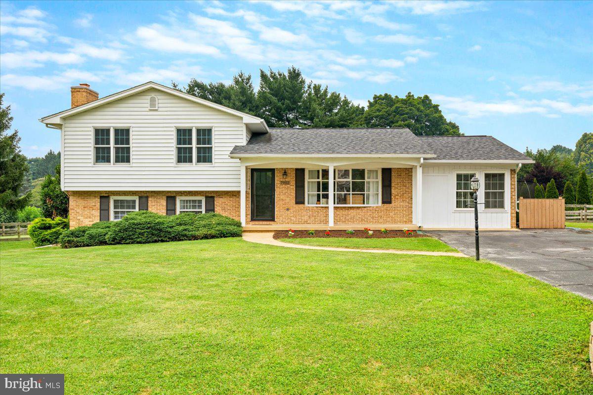 Welcome to this stunning split-level residence quietly nestled on a spacious corner lot in the desirable West Hill community, a neighborhood with no HOA or city taxes, and access to Clover Hill amenities including a neighborhood pool! A charming covered front porch welcomes you inside, where gleaming hardwood floors and an open-concept layout set the tone for modern, comfortable living. The main level has been expanded over the years creating an exceptionally unique and compelling open-concept. The entry level shines with a freshly painted interior and a thoughtfully converted bonus space, now a bright and versatile area perfect for entertaining, relaxing, or working from home. The kitchen is a true centerpiece, featuring granite countertops, a center island, stylish backsplash, and soft-close cabinetry. Upstairs, the updated primary suite offers a tranquil retreat with a private upgraded ensuite bath, joined by two additional generously sized bedrooms and a full bath with ceramic tile and dual granite vanities. The lower level adds even more living space anchored by a cozy stone wood-burning fireplace, a full bath, and ample storage and laundry space. It is a four level split which creates ample storage in the lower fourth level. Step outside to a fully fenced backyard with a large patio and pergola, a thriving garden, and established berry bushes. The possibilities are endless as you can build the ADU of your dreams or currently set up for outdoor activities on summer nights hosting family and friends.  Additional highlights include a whole-house water filtration system and a well-maintained septic system and HVAC, true peace of mind for the next owner. Ideally located just minutes from Baker Park, Downtown Frederick's dining and boutiques, Wegmans, Fort Detrick, and easy access to Rt. 15, I-270, and I-70. This one is a rare find - don't miss it!