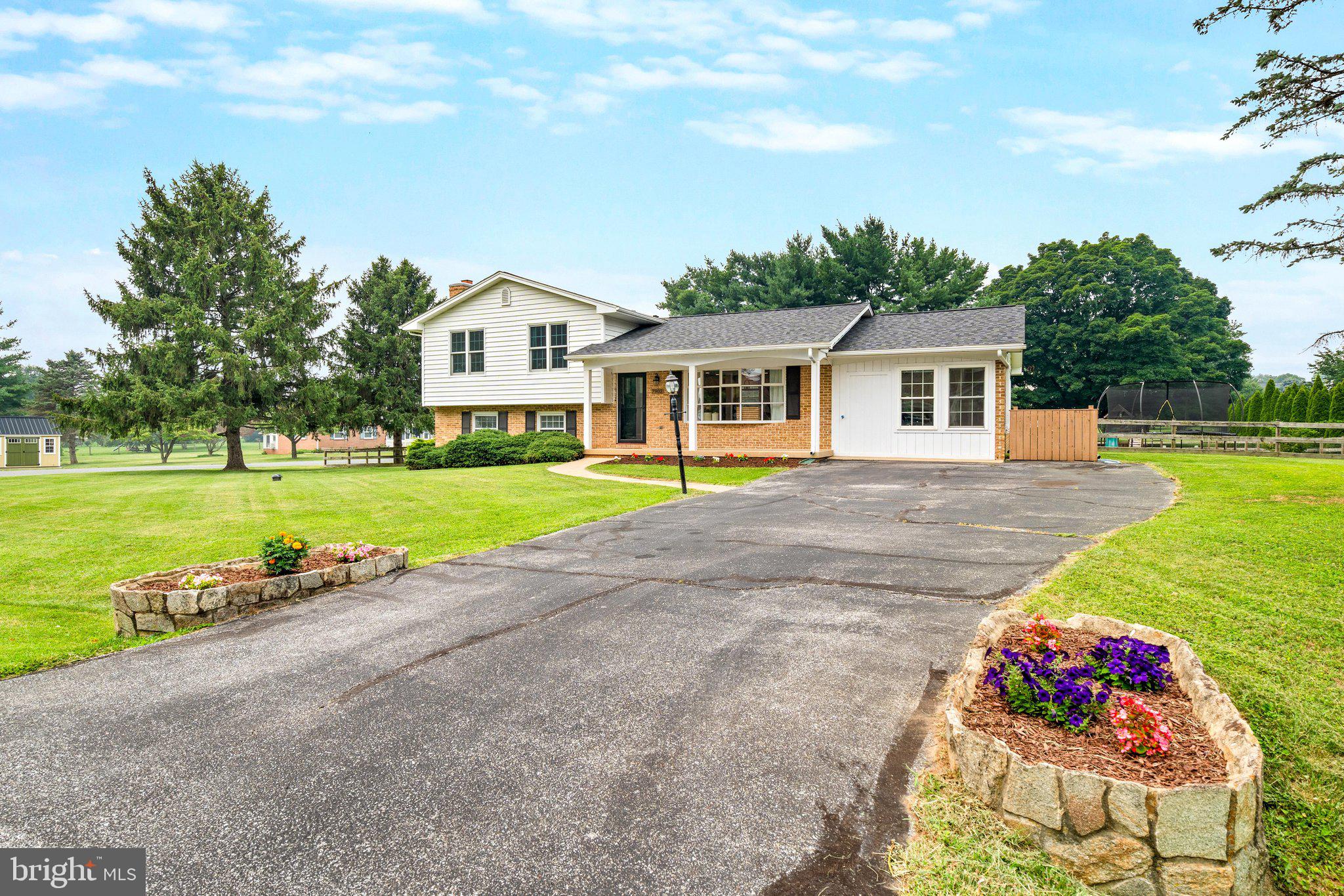 Welcome to this stunning split-level residence quietly nestled on a spacious corner lot in the desirable West Hill community, a neighborhood with no HOA or city taxes, and access to Clover Hill amenities including a neighborhood pool! A charming covered front porch welcomes you inside, where gleaming hardwood floors and an open-concept layout set the tone for modern, comfortable living. The main level has been expanded over the years creating an exceptionally unique and compelling open-concept. The entry level shines with a freshly painted interior and a thoughtfully converted bonus space, now a bright and versatile area perfect for entertaining, relaxing, or working from home. The kitchen is a true centerpiece, featuring granite countertops, a center island, stylish backsplash, and soft-close cabinetry. Upstairs, the updated primary suite offers a tranquil retreat with a private upgraded ensuite bath, joined by two additional generously sized bedrooms and a full bath with ceramic tile and dual granite vanities. The lower level adds even more living space anchored by a cozy stone wood-burning fireplace, a full bath, and ample storage and laundry space. It is a four level split which creates ample storage in the lower fourth level. Step outside to a fully fenced backyard with a large patio and pergola, a thriving garden, and established berry bushes. The possibilities are endless as you can build the ADU of your dreams or currently set up for outdoor activities on summer nights hosting family and friends.  Additional highlights include a whole-house water filtration system and a well-maintained septic system and HVAC, true peace of mind for the next owner. Ideally located just minutes from Baker Park, Downtown Frederick's dining and boutiques, Wegmans, Fort Detrick, and easy access to Rt. 15, I-270, and I-70. This one is a rare find - don't miss it!