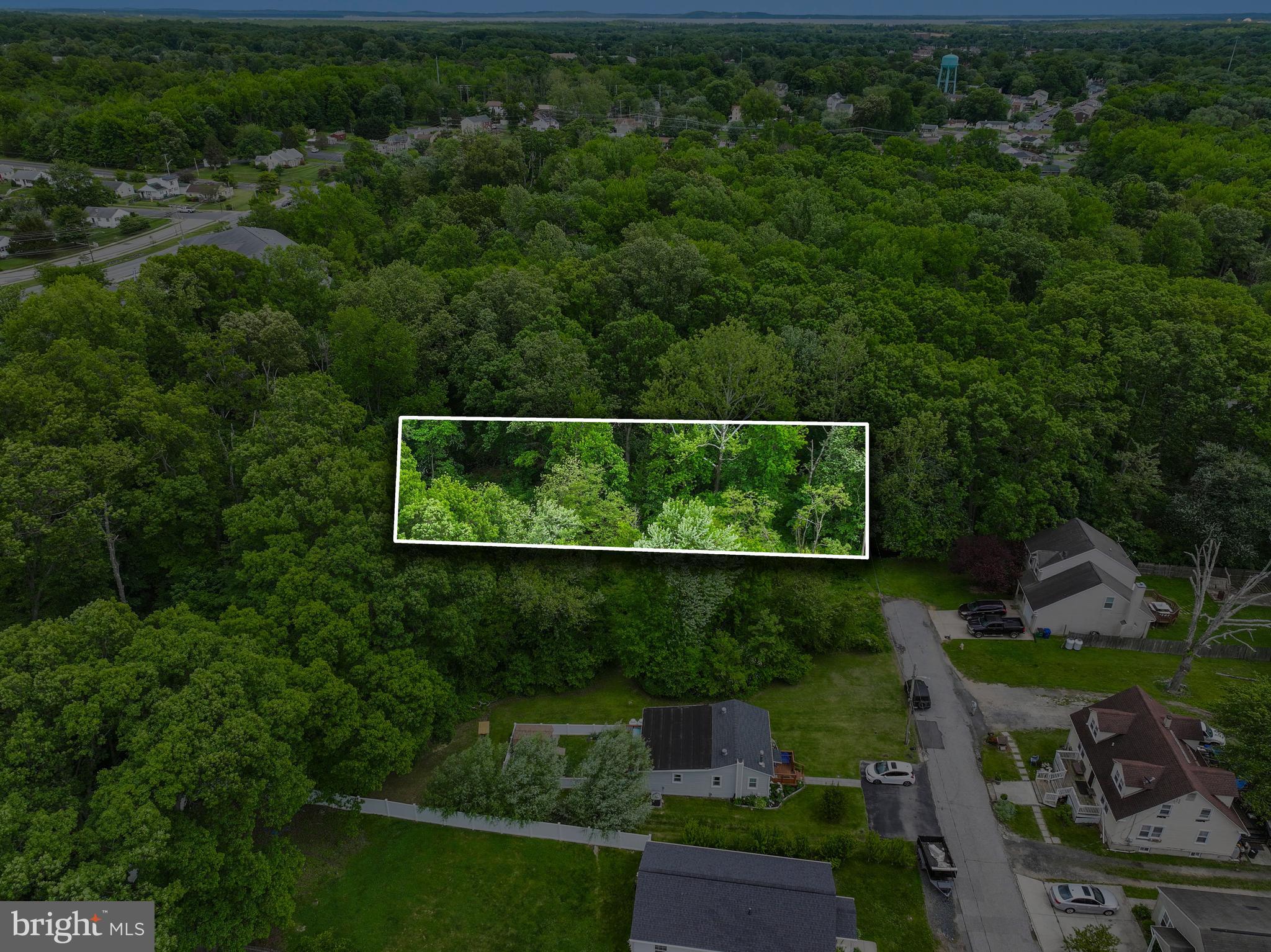 The area surrounding the subject property features a mix of developed neighborhoods with properties averaging 0.3 to 1 acre, alongside commercial shopping, restaurants, and rural woodlands. Strategically located, the property sits within 1.3 miles of downtown Aberdeen, Maryland, 1.5 miles from US Route 40 (Pulaski Highway), and 1.4 driving miles from Interstate 95. The site offers approximately 15 to 20 feet of frontage along Battle Avenue with entirely unobstructed access, featuring no built-up curbs or physical impediments. The terrain is gently sloped and free of significant gullies, hills, or culverts, though the soil is acrid and primarily soft, which will likely require backfill to stabilize the ground and ensure proper drainage during development. Additionally, the lot is heavily wooded with thick undergrowth, features a sparse scattering of small rocks under one foot in diameter, and contains a dilapidated 20' x 30' block foundation standing less than 3 feet tall. Despite the dense vegetation, the land presents a straightforward development opportunity, and because surrounding properties are fully serviced by public utilities—including electricity, cable, water, and sewer—there are no apparent obstacles to connecting these services once a new structure is built.   Please verify with Town and County.  Seller willing to finance the parcel with reasonable down payment.  See Lot 29 highlighted in red on photo.