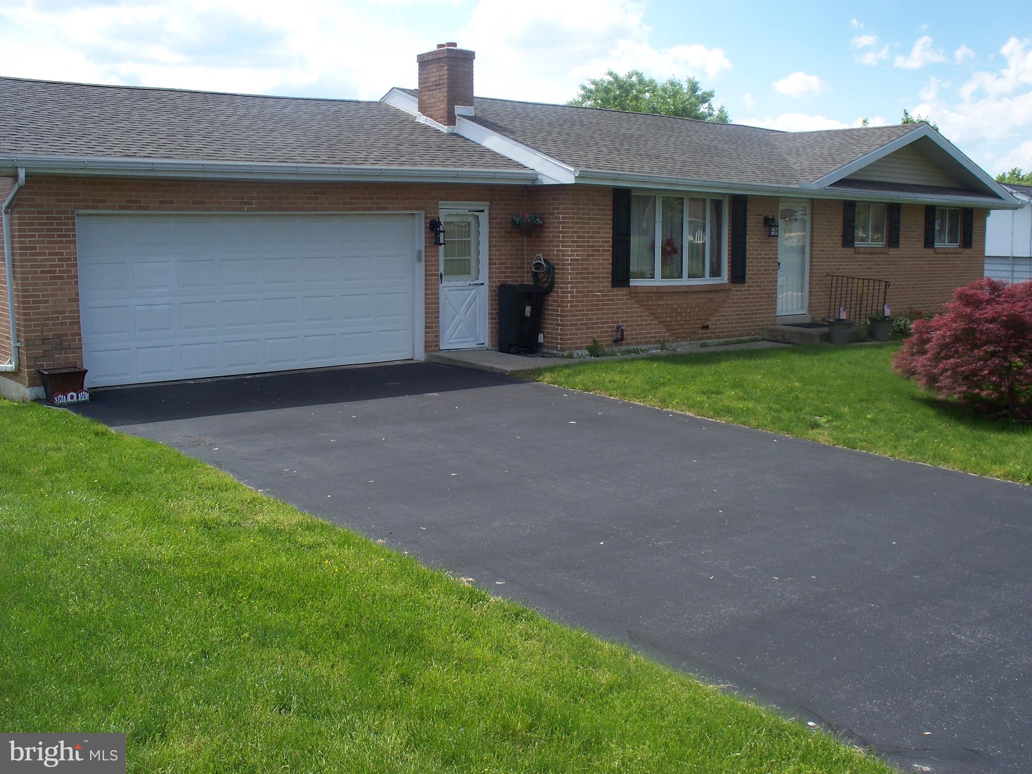Brick rancher with full walk-out basement offers main floor entry into living room with hardwood flooring and wood-burning fireplace, open kitchen/dining room, 2 primary bedrooms and hall bath.  Lower level includes family room, spare bdrm (or den), additional full bath, and laundry/storage area.  Attached 2-car garage w/elect opener can be accessed from kitchen plus egress to rear yard. Improvements include newer roof and siding (2018).  Home warranty included for purchaser.
