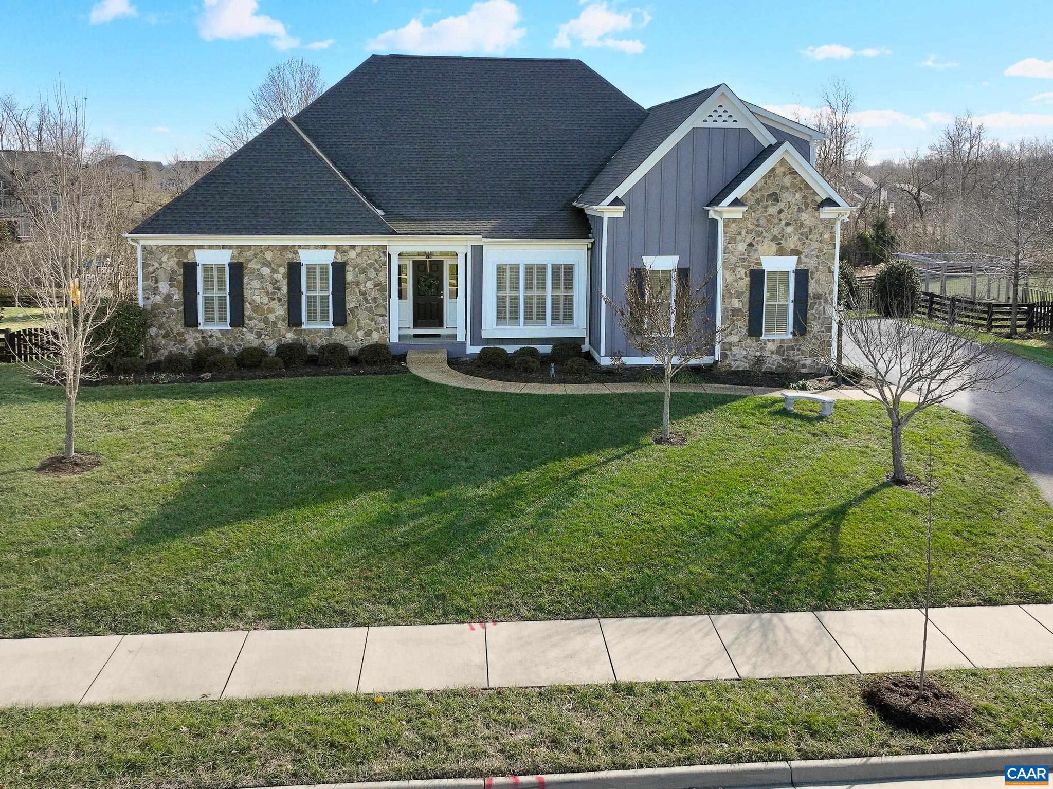 One level living in Old Trail Creekside on over half an acre. This beautiful home from Craig Builders has been meticulously maintained! Hardwood floors, custom window treatments, and upgraded trim and moulding details throughout the main level! Book lovers will love the home office with built-in shelving and French doors. Entertain in the formal dining room or in the large great room with soaring ceiling, stone fireplace with tv and built-in shelves on either side that opens to the gourmet kitchen with wood cabinets and two level granite breakfast bar. Dine or relax in the two light-filled sunrooms with access to the large deck and private rear yard overlooking the nature trail! The main level owner's suite features a spa-like bathroom with soaking tub and walk-in tile shower. Two additional spacious bedrooms share a full bathroom on the main level. Upstairs, the finished bonus room and full bathroom offers flexible options including a guest suite, playroom or media room. The walk out basement with access to screened porch and patio features a second sun room and rec room, and multiple unfinished spaces offer great space to expand!,Granite Counter,Wood Cabinets,Fireplace in Great Room