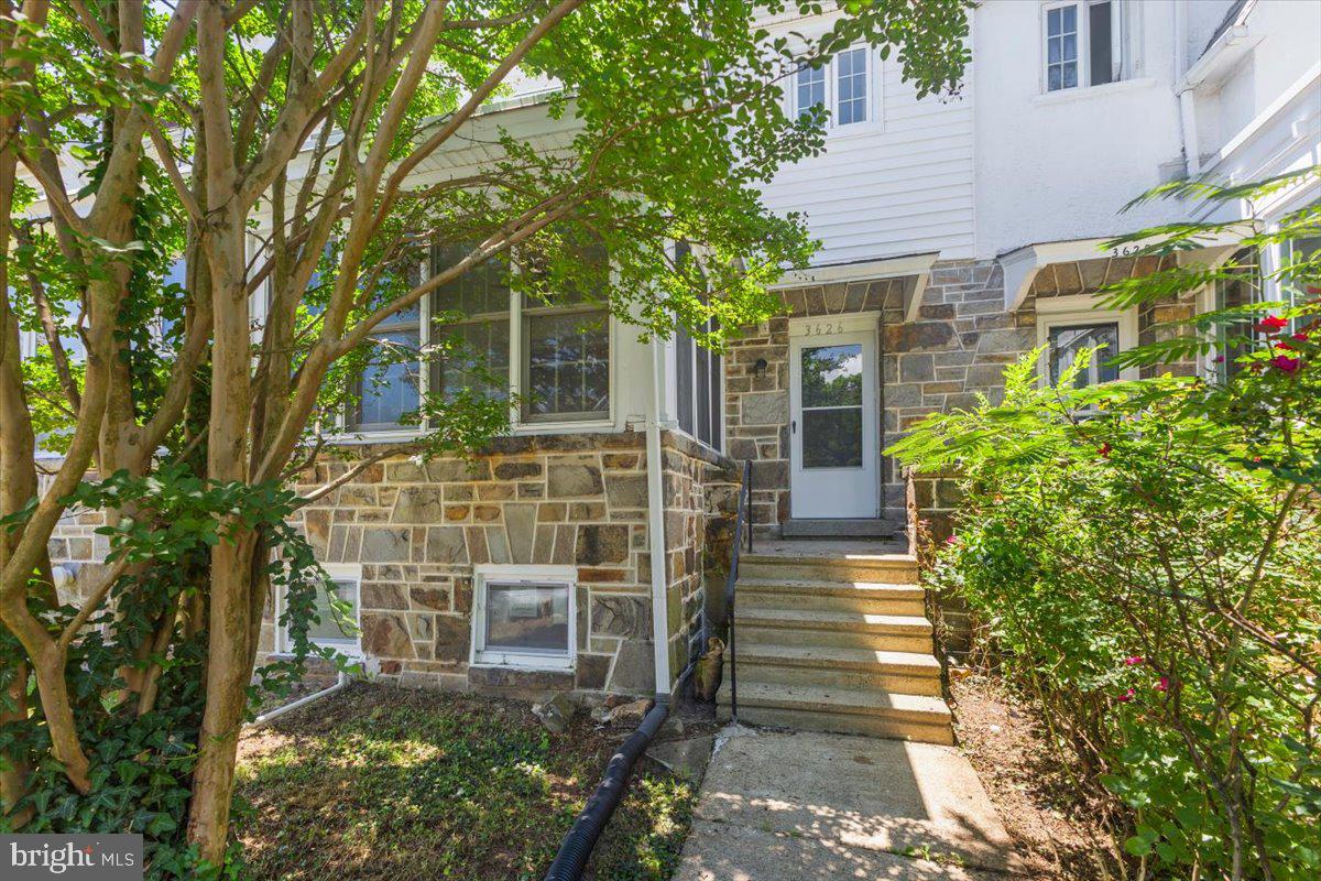 Welcome to this charming 1930s Tudor-style townhome nestled in the highly sought-after, tree-lined historic community of Ednor Gardens! Boasting 3 spacious bedrooms, 1 full bath, and 2 convenient half baths, this home perfectly blends classic character with modern functionality. The main level welcomes you with a traditional floor plan featuring glowing hardwood floors with a bright, open living space and a bonus bump out sun porch AND a walk out full deck. The kitchen is completely renovated and is crisp and white. Upstairs features three comfortable bedrooms and a full central bath. The partially finished basement adds excellent additional living square footage, a second half bath, and seamless garage access. Enjoy unparalleled convenience just minutes from Johns Hopkins University, Morgan State University, the YMCA, and outdoor recreation at Lake Montebello!