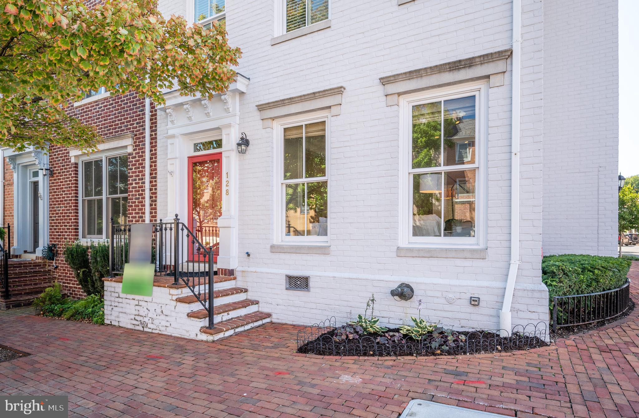 Gorgeously updated and rarely available end-unit in Queens Row! This stunning townhome features three bedrooms, three full  baths and one half bath. Enter into the large foyer where you will be swept away by the tall ceilings, beautiful moldings and gorgeous hardwood flooring. A beautiful living room with gas fireplace flows easily into the formal dining room - a great space for dinner parties or hosting holiday meals! The kitchen is truly a chef's paradise. Updated with beautiful countertops, stainless appliances, loads of custom cabinetry and prep-space for days - even the most discerning chef will feel right at home. Enjoy morning coffee or casual dinners in the eat-in area, and walk out to your private Georgetown-style patio through French doors. A great place to grill, entertain or even work from home, the private patio is a perfect spot and also features two sheds for storage! Head upstairs and you will find a family room with gas fireplace - a great space for evening movie night. A large primary suite is located off the family room - featuring two walk-in closets and a spa-like, ensuite bath with updated fixtures, tile and a large shower. On the second upper level are two additional bedrooms with en-suite baths. Looking for more outdoor space... you can add a rooftop deck - stunning water views and spectacular entertaining! Two assigned parking spaces are located in the rear - just a short walk to the courtyard and kitchen entrance of the home. Queens Row is a private community of 25 townhomes - located next to Founder's Park and within walking distance to shops, restaurants and all the conveniences of Old Town! Minutes to the King Street Metro, the GW Parkway, Reagan National, the Mount Vernon Trail and more, you will love living here! Welcome Home!