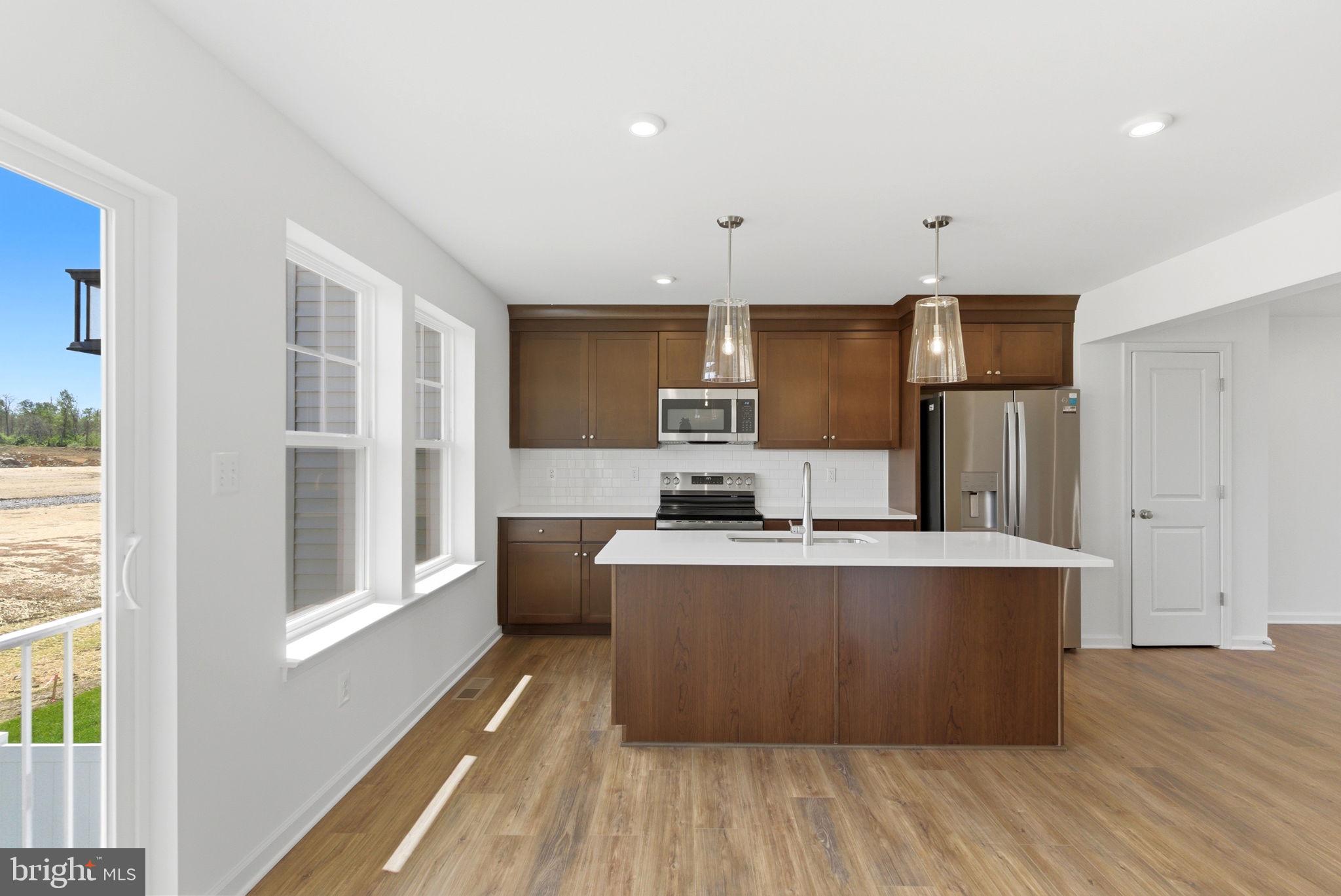 **UP TO $10,000 CLOSING COST ASSISTANCE FOR PRIMARY RESIDENCE WITH USE OF APPROVED LENDER AND TITLE!**
NEW CONSTRUCTION TOWNHOME | ESTIMATED SEPTEMBER COMPLETION | COMMUTER-FRIENDLY LOCATION Now is the perfect time to secure your new home in Boyd's Crossing! This beautifully designed new construction townhome offers approximately 1,650 square feet of modern, low-maintenance living with an estimated completion date of mid-September, giving buyers the opportunity to move into a brand-new home this fall. Located just minutes from I-81 and only a short drive from the Virginia state line, Boyd's Crossing is one of the Eastern Panhandle's most convenient commuter communities. Enjoy easy access to Northern Virginia, Winchester, and surrounding employment centers while taking advantage of the affordability and lifestyle West Virginia has to offer. Inside, you'll find an open-concept floor plan designed for today's lifestyle, featuring a stylish kitchen with quartz countertops, a designer tile backsplash, ample cabinetry, and a spacious island that overlooks the main living and dining areas. The thoughtful layout creates an inviting space for entertaining, working from home, or simply relaxing with others. This new townhome combines modern finishes, energy-efficient construction, and functional living spaces to provide exceptional value for first-time buyers, changing household needs, or anyone seeking a low-maintenance lifestyle. Residents will enjoy community open space and convenient access to shopping, dining, schools, and major commuter routes. Even better, buyers may qualify for closing cost assistance when using the builder's approved lender and title company. Plus, every home includes a comprehensive new home warranty, providing added confidence and peace of mind long after move-in day. Don't miss your chance to own a brand-new townhome with a fall move-in timeline in one of the area's fastest-growing communities. Contact us today for more information and to reserve your new home before it's gone.*Photos may not be of actual home. Photos may be of similar home/floorplan if home is under construction or if this is a base price listing.