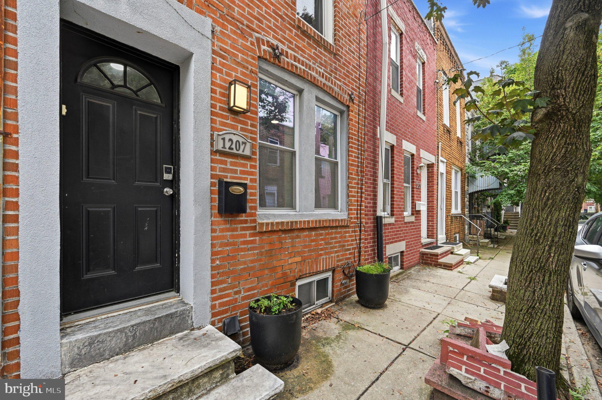 Beautifully renovated two-bedroom home on a quiet South Philadelphia block near Passyunk Square! 1207 S. Marshall Street features an open layout with hardwood floors, recessed lighting, and abundant natural light throughout. The updated kitchen offers granite countertops, stainless steel appliances, white cabinetry, and bar seating perfect for entertaining. Upstairs includes two spacious bedrooms and a stylish bathroom with double sinks and a stand up shower. The finished basement provides additional living space ideal for a home office, gym, or media room. Complete with central air, updated systems, and a private rear patio, this move-in ready home is conveniently located across from Gold Star park, shopping, and public transportation.