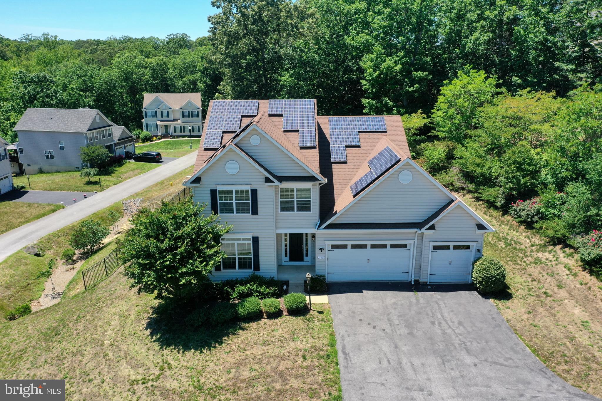 Offered for the first time, this single-owner custom home in The Woods at Myrtle Point delivers 3479 finished square feet of thoughtful upgrades and modern, energy-smart systems. Built in 2012 on a private 0.72-acre lot — one of just five homes on the street — it features a customized Abberly elevation with 2-foot extensions to the kitchen, office, and third bedroom. The gourmet kitchen showcases a new LG ThinQ appliance suite, tile backsplash, and exterior-vented exhaust, while Brazilian cherry hardwoods, recessed lighting, and a gas fireplace warm the main level. The primary suite includes an 80-gallon soaking tub. The finished lower level adds a wet bar, full bath, rec room, dedicated workout space, and ample storage — framed for easy conversion to a fifth bedroom or den. Standout systems: a fully owned 7.9 kW solar array that conveys with the home, natural-gas tankless water heater, replaced upstairs HVAC, 60-amp EV charger, Ring cameras, and smart locks. Outside, enjoy an  800 sq ft paver patio and zoned front-and-rear irrigation. Community clubhouse, pool, and more.