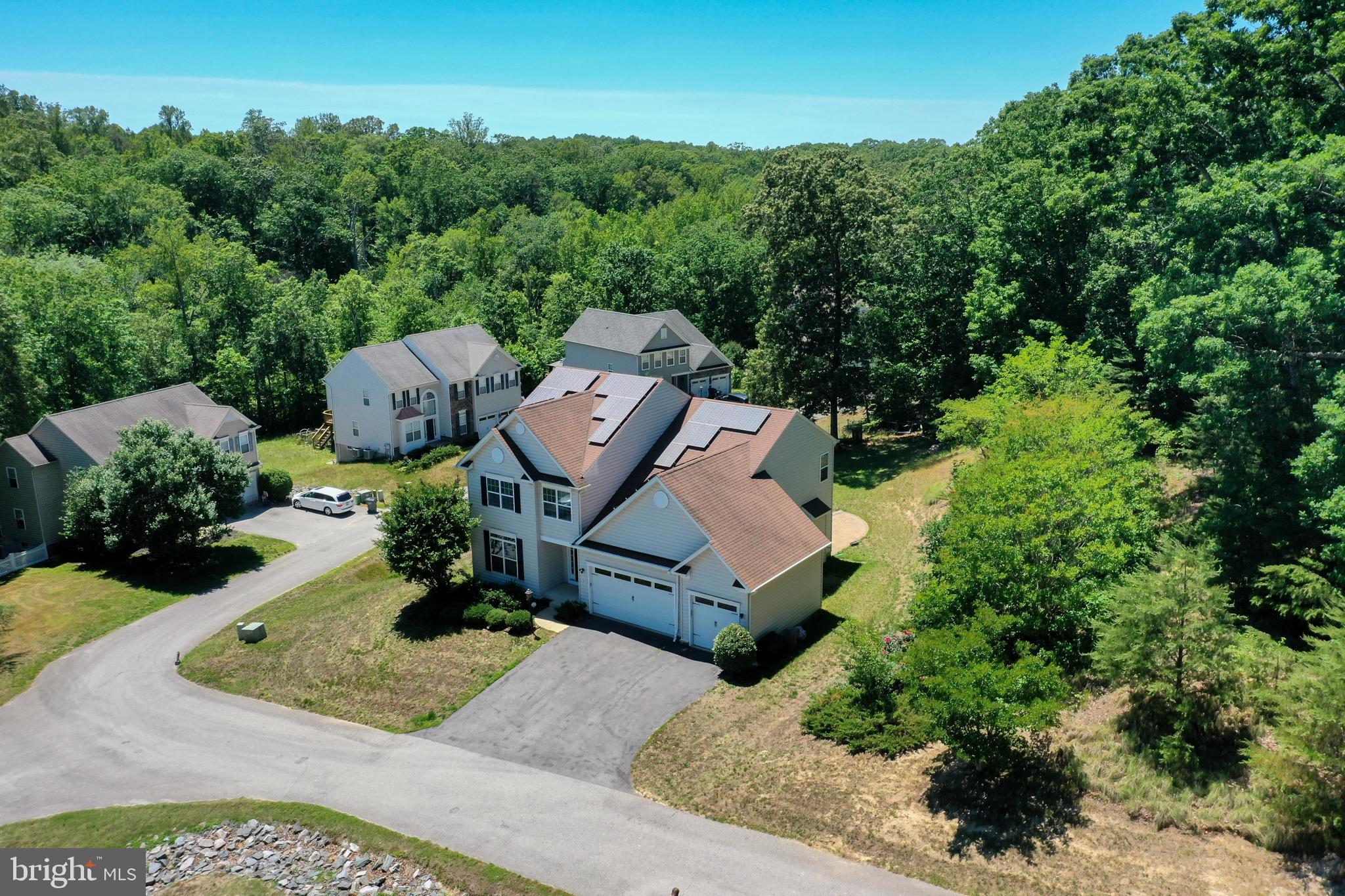 Offered for the first time, this single-owner custom home in The Woods at Myrtle Point delivers 3479 finished square feet of thoughtful upgrades and modern, energy-smart systems. Built in 2012 on a private 0.72-acre lot — one of just five homes on the street — it features a customized Abberly elevation with 2-foot extensions to the kitchen, office, and third bedroom. The gourmet kitchen showcases a new LG ThinQ appliance suite, tile backsplash, and exterior-vented exhaust, while Brazilian cherry hardwoods, recessed lighting, and a gas fireplace warm the main level. The primary suite includes an 80-gallon soaking tub. The finished lower level adds a wet bar, full bath, rec room, dedicated workout space, and ample storage — framed for easy conversion to a fifth bedroom or den. Standout systems: natural-gas tankless water heater, replaced upstairs HVAC, 60-amp EV charger in the garage, Ring cameras, and smart locks. Outside, enjoy an  800 sq ft paver patio and zoned front-and-rear irrigation. And if that's not enough there is a community clubhouse and pool.  AND to top it all off, enjoy the benefits of a FULLY-OWNED solar panel system—no lease or loan to assume. The system was designed to help offset household energy consumption and lower monthly electric bills. During periods of strong solar production, excess energy may be eligible for utility net-metering credits (subject to utility provider guidelines and buyer enrollment). This is a valuable energy-efficient feature that can contribute to long-term savings while supporting renewable energy use.