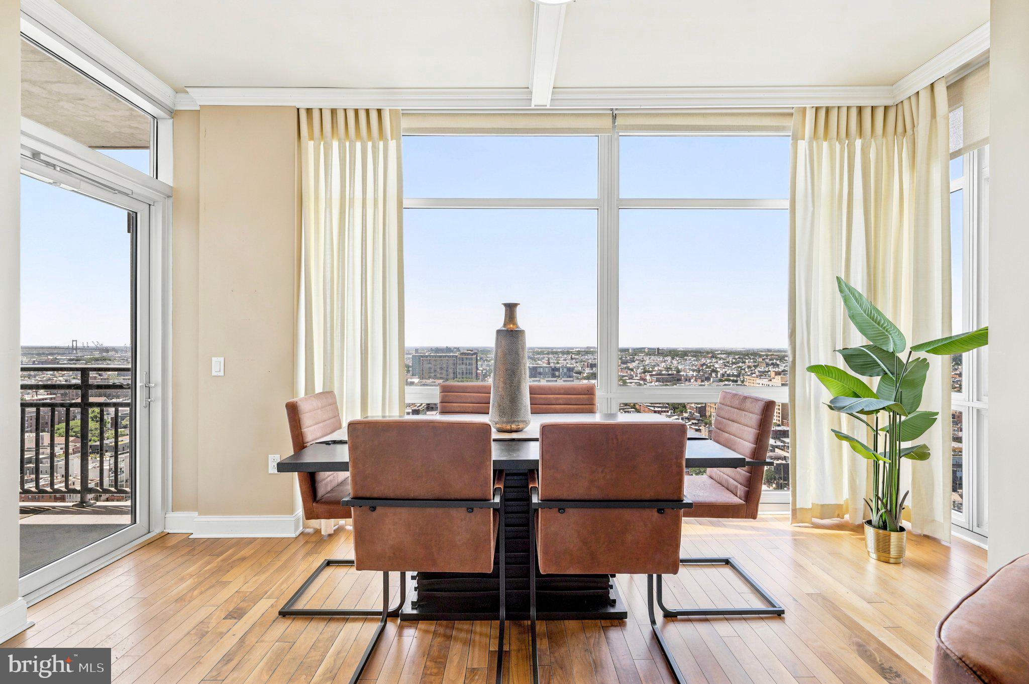 Welcome to this sophisticated and elegant Philadelphia condominium showcasing breathtaking panoramic skyline views, luxurious finishes, and exceptional architectural detail throughout. From the moment you enter the gracious foyer, you are immediately drawn to the stunning open-concept design and dramatic walls of windows that flood the home with natural light.

The spectacular gourmet kitchen is beautifully appointed with GE stainless steel appliances, gas cook top, oversized island with seating, farmhouse sink, newer custom cabinetry, and designer finishes throughout. Perfectly designed for both entertaining and everyday living, the kitchen flows seamlessly into the expansive living and dining areas.

The elegant living room is truly unforgettable, featuring rich hardwood flooring, coffered ceilings, sophisticated fireplace with built-ins, and sweeping city views that create a breathtaking backdrop from nearly every room. The adjoining dining area is surrounded by floor-to-ceiling windows, offering spectacular panoramic views of the Philadelphia skyline and direct access to the private balcony — the perfect setting for morning coffee or evening cocktails overlooking the city.

The luxurious primary suite offers magnificent views, professionally designed walk-in closets, and a spa-inspired marble bathroom with exquisite marble finishes and exceptional space.

The spacious second bedroom also features incredible views, a walk-in closet, and access to a beautifully appointed Jack-and-Jill bath connecting to the versatile office or den — ideal for guests, working from home, or additional living space.

Residents enjoy an unparalleled luxury lifestyle with exceptional building amenities including 24-hour concierge service, resort-style pool, relaxing sauna, elegant resident dining and entertaining room complete with kitchen for hosting family and guests, beautifully appointed library, private wine room, and so much more.

This extraordinary residence offers elevated city living with timeless sophistication, exceptional comfort, and world-class amenities in one of Philadelphia’s most desirable addresses. When any of our beloved sports team wins, just watch the parade from the comfort of your home.