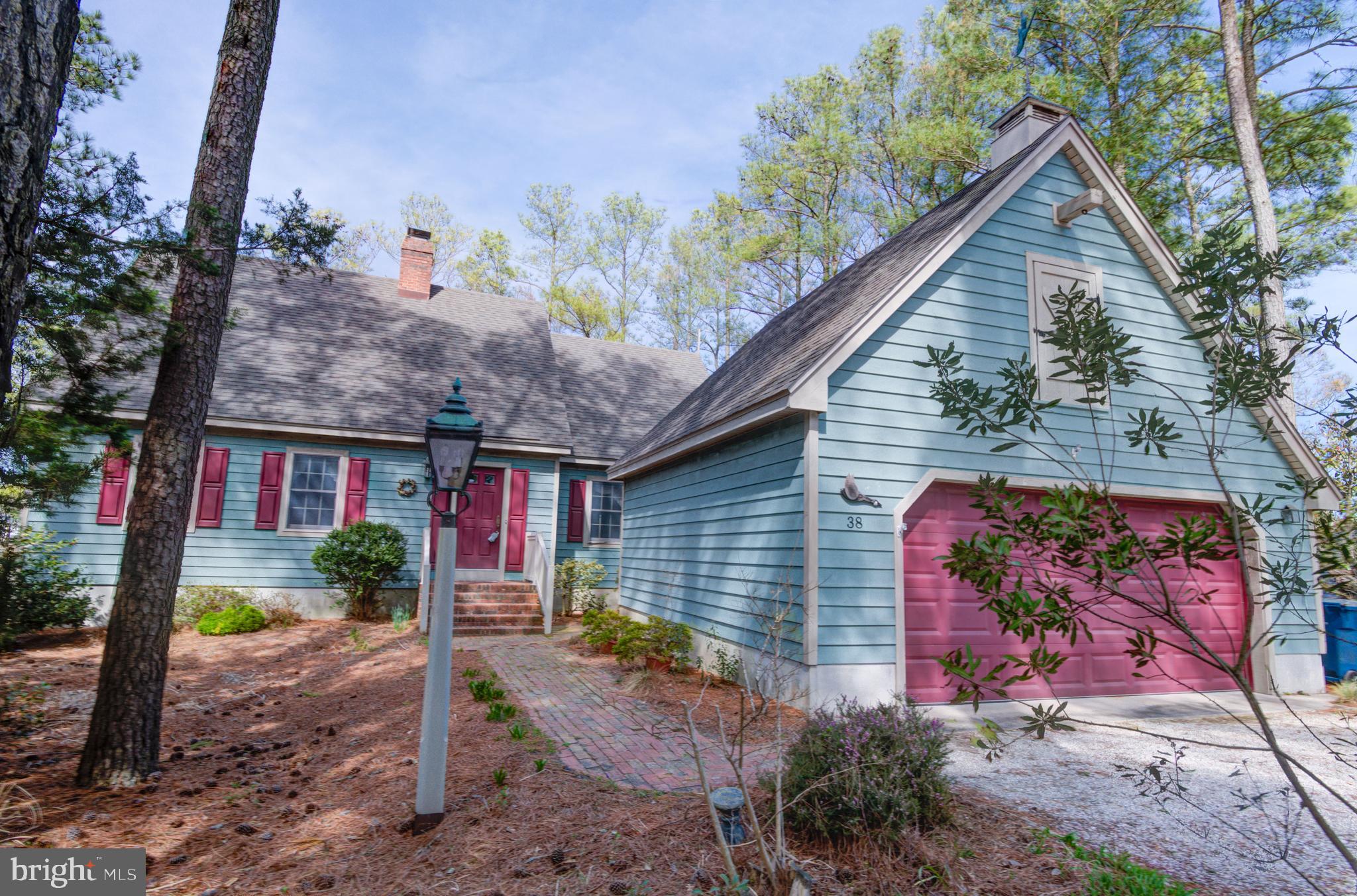 Your Classic Colonial dream home with panoramic Manklin Creek water views is waiting for you here in Ocean Pines. Primary Suite updated recently with a primary bath plus a large extra room which could be used as a Family Room or office. Sunroom with HVAC Mini split is just off the Formal Dining Room. Large gracious formal dining room has a cozy wood fireplace plus a built-in seating area by a window to enjoy the views. Living room, just inside the 6x6 tile entry foyer, also has a wood fireplace and lots of built-in bookshelves to show off your collectibles. 2 very spacious bedrooms and full bath are on the upper level. One has a walk-in closet for out of season clothes. The four poster bed and large desk will stay if desired. Crawl space has been encapsulated. New roof and HVAC in 2016. Microwave and dryer new in 2024. New rear deck and railings done in 2025. 22x22 detached garage has a staircase to floored attic but it could be an artist's studio or workshop. Easy to see.