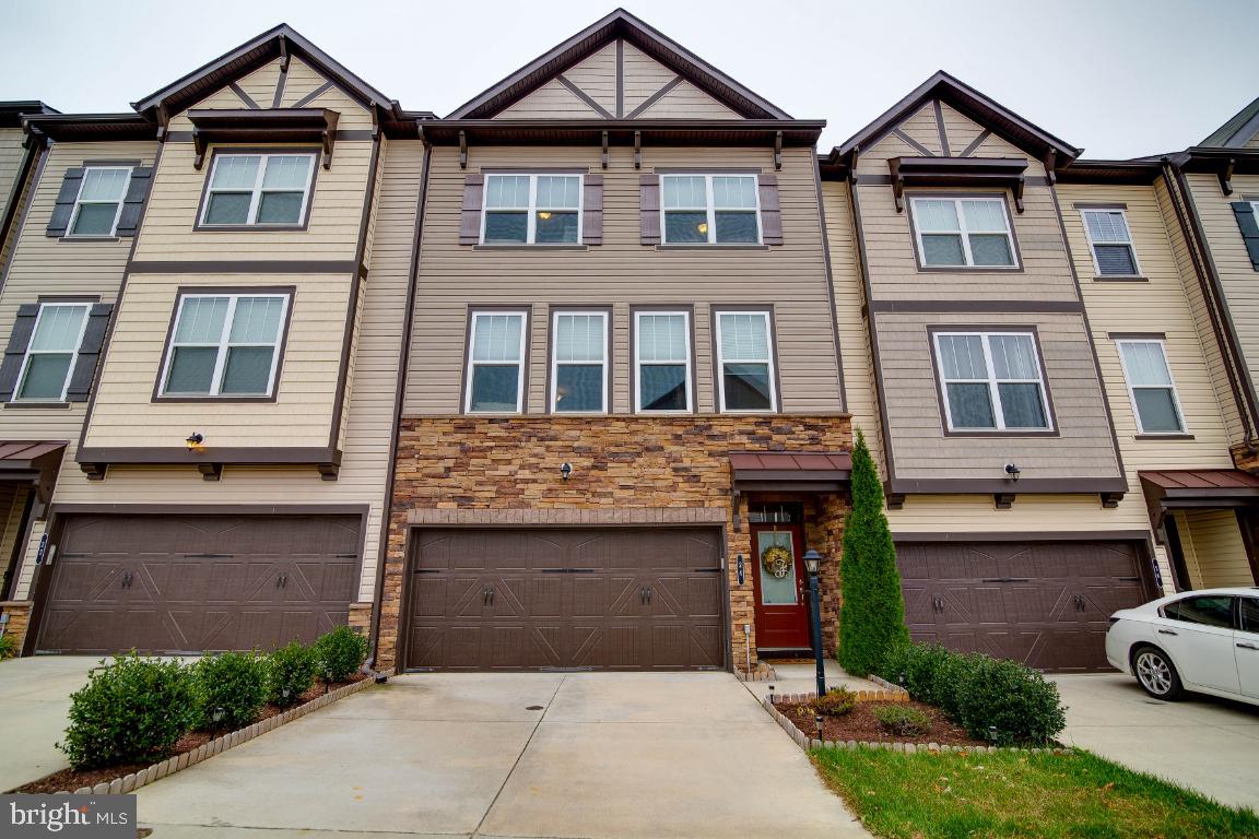 Beautiful 3 Level townhouse with 2 car garage in excellent condition!! Lots of upgrades.  Upper Level wood flooring recently added,  Large master bed room with sitting area.  Gourmet kitchen with Granite counters, stainless Steel appliances, kitchen Island, Gas cooking and recessed lights. Spacious main living level, with lots of room, with Family Room, Dining Area and Huge living room.  Well designed out of the way Powder room.  Private front Foyer entrance, or enter from the garage.  Fully finished basement, wonderfully  designed for living with the convenience of a gas fireplace, and a bath.  Come see this Fabulous home!!
